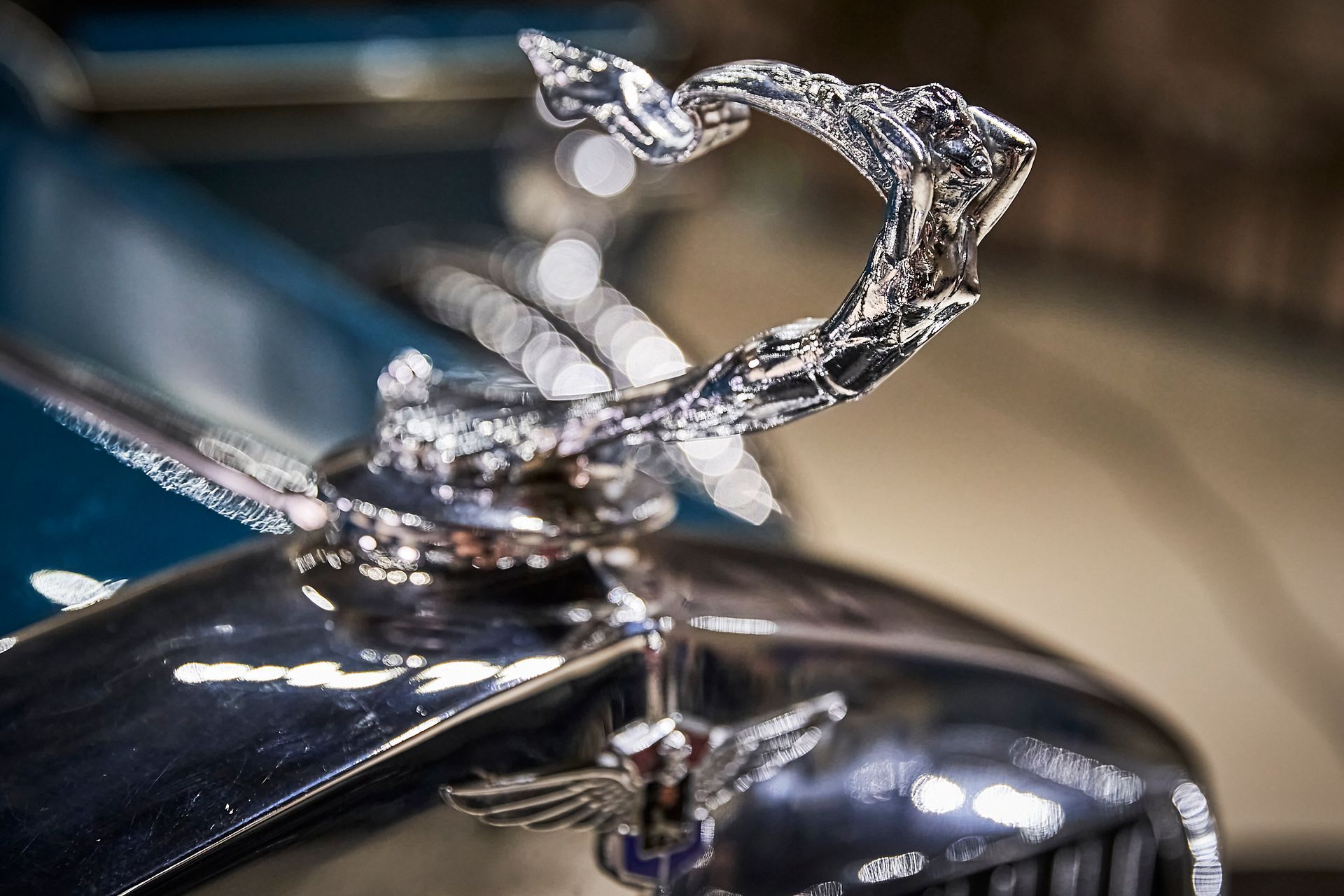 A close up of a car with a hood ornament on it.