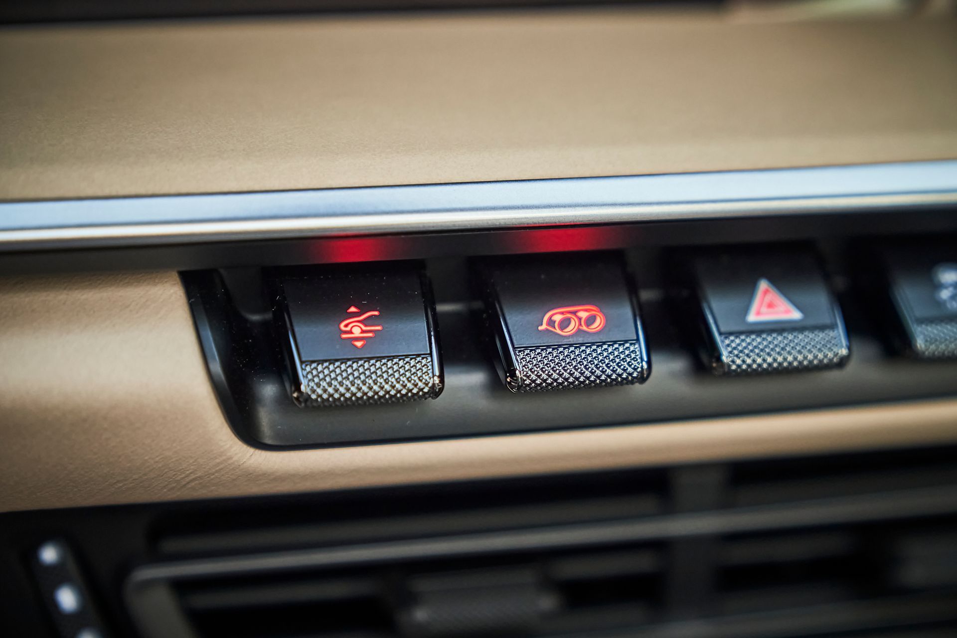 A close up of a car dashboard with a lot of buttons on it.