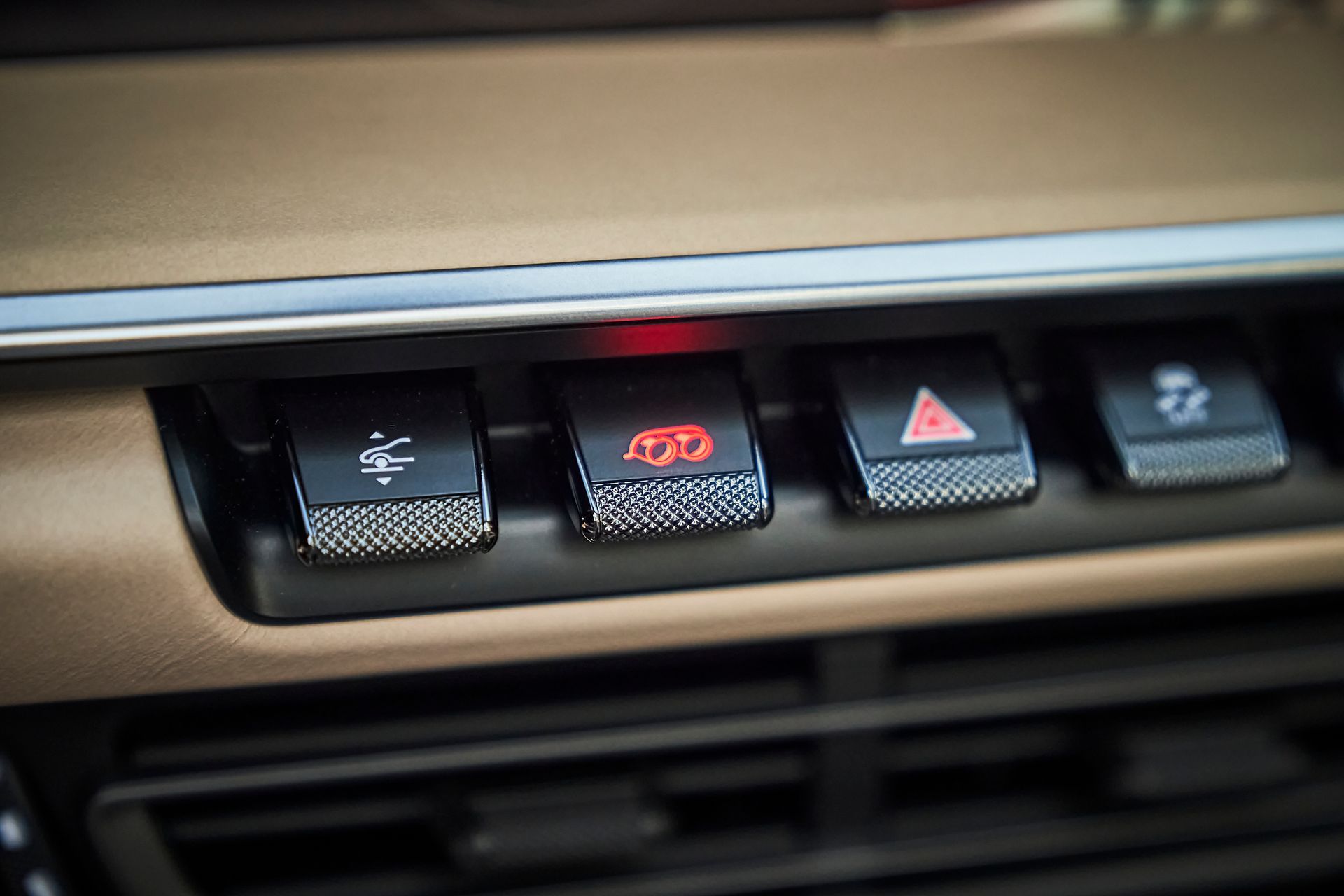 A close up of a car dashboard with a lot of buttons on it.