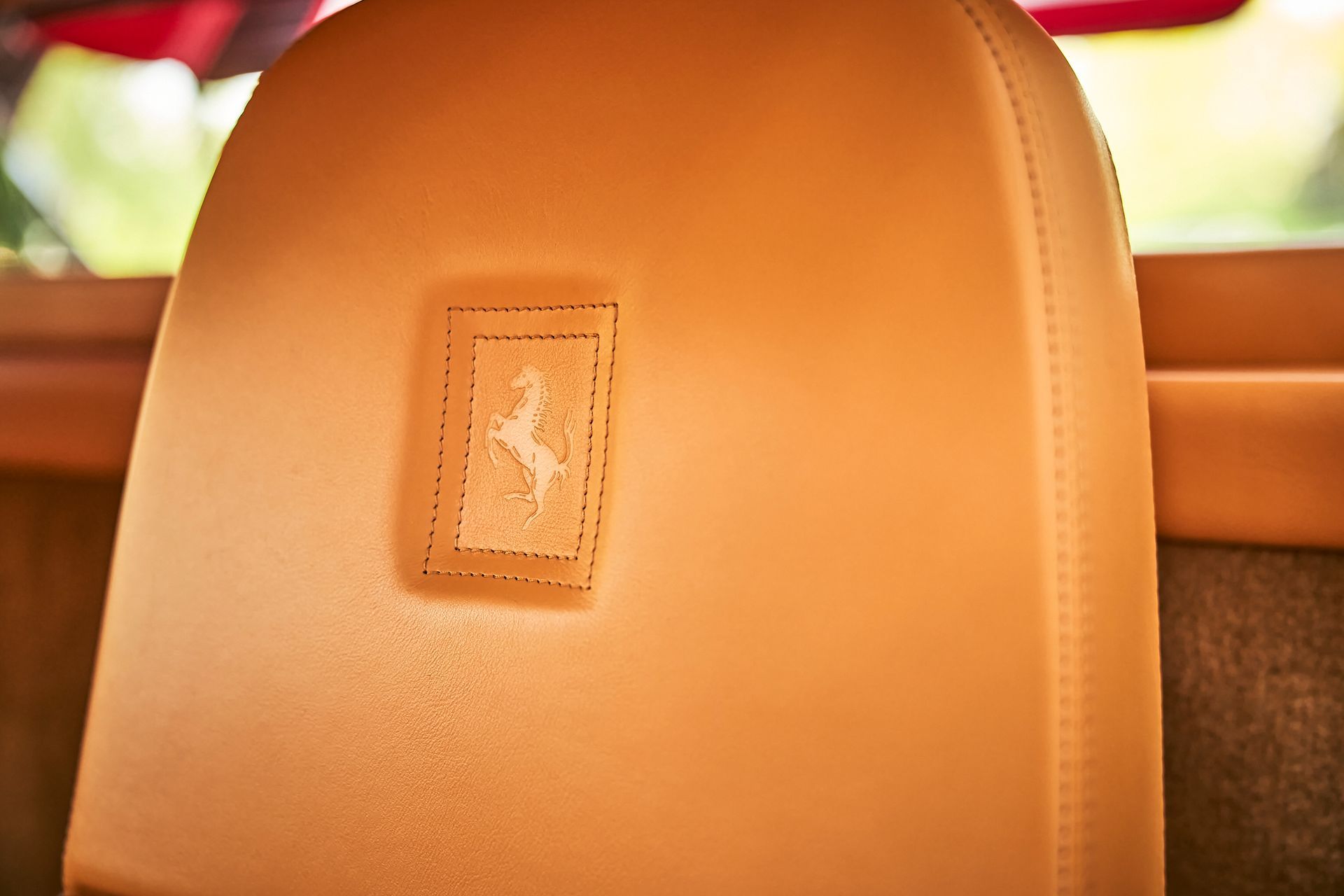 A close up of a car seat with a ferrari logo on it