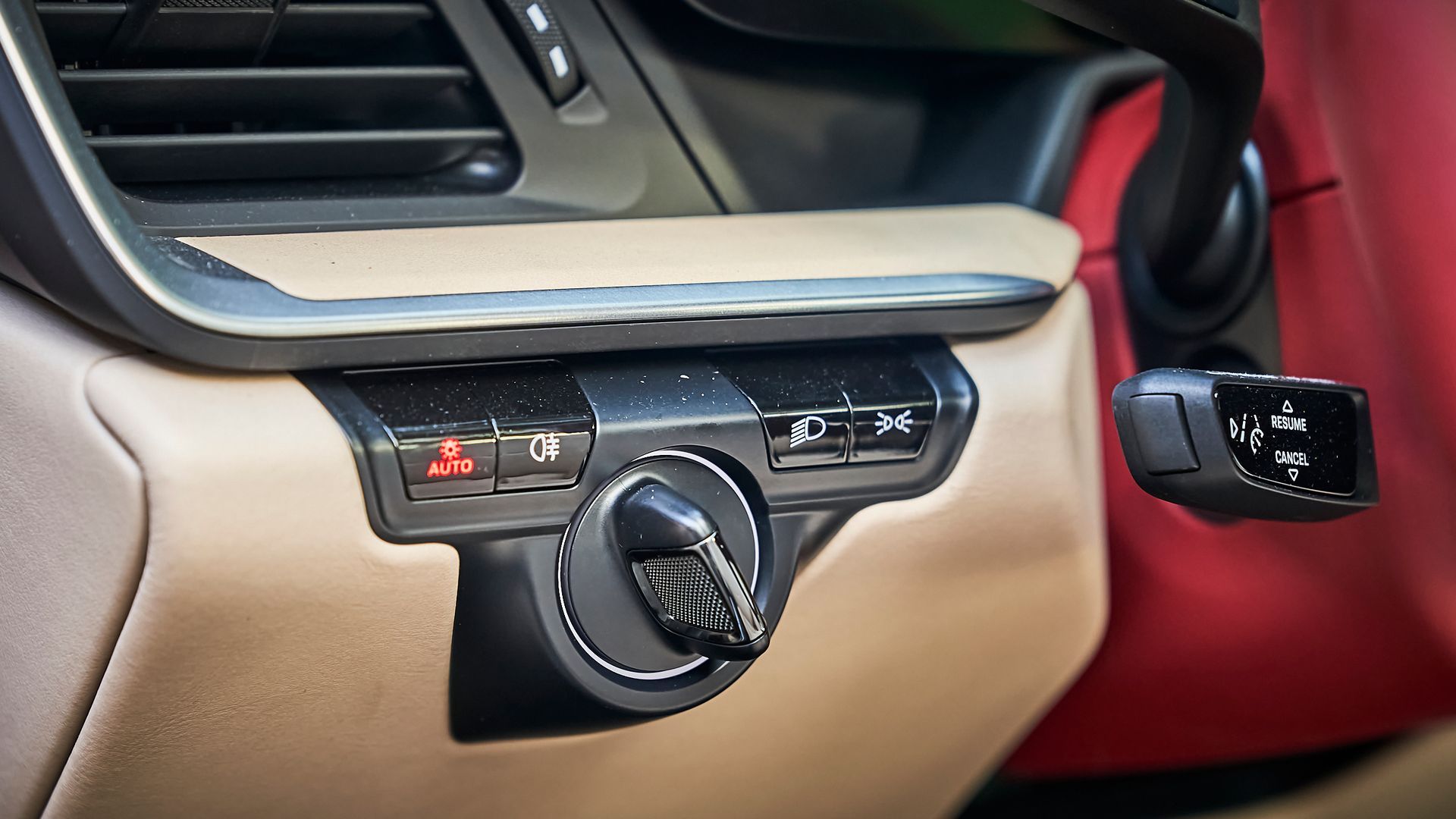 A close up of a car dashboard with a steering wheel and a shifter.