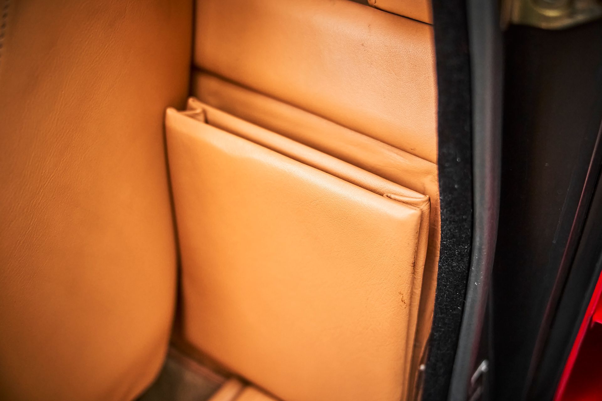A close up of a pocket in the back seat of a car.