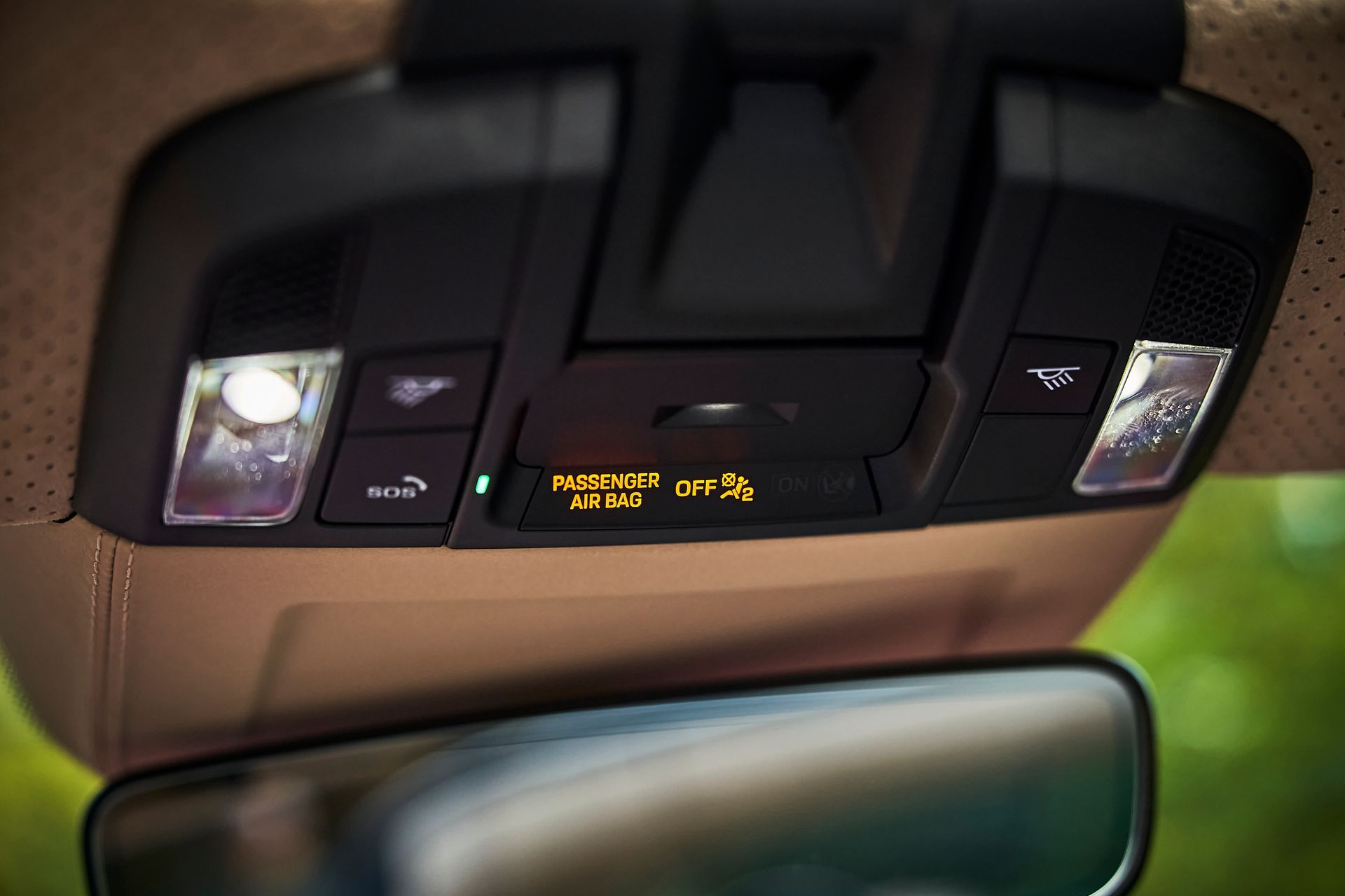 A close up of a car dashboard with a rear view mirror.