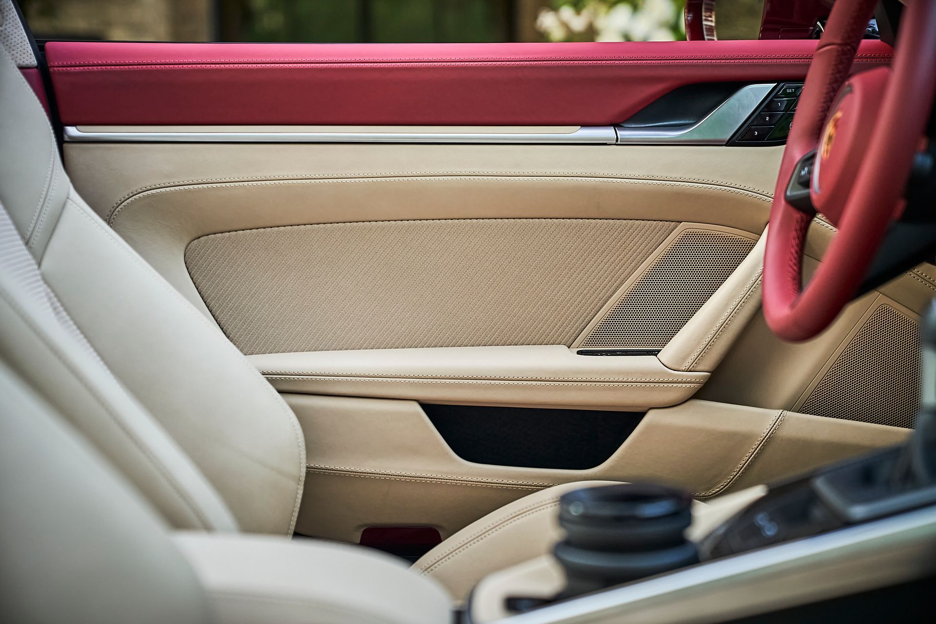 A close up of a car door with a red trim