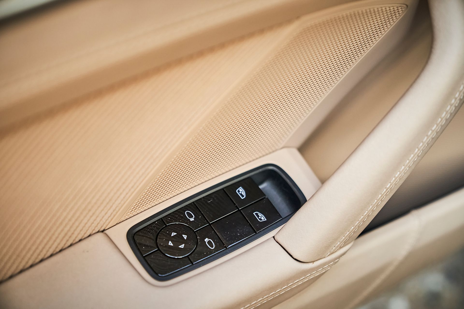 A close up of a car door with a remote control on it.