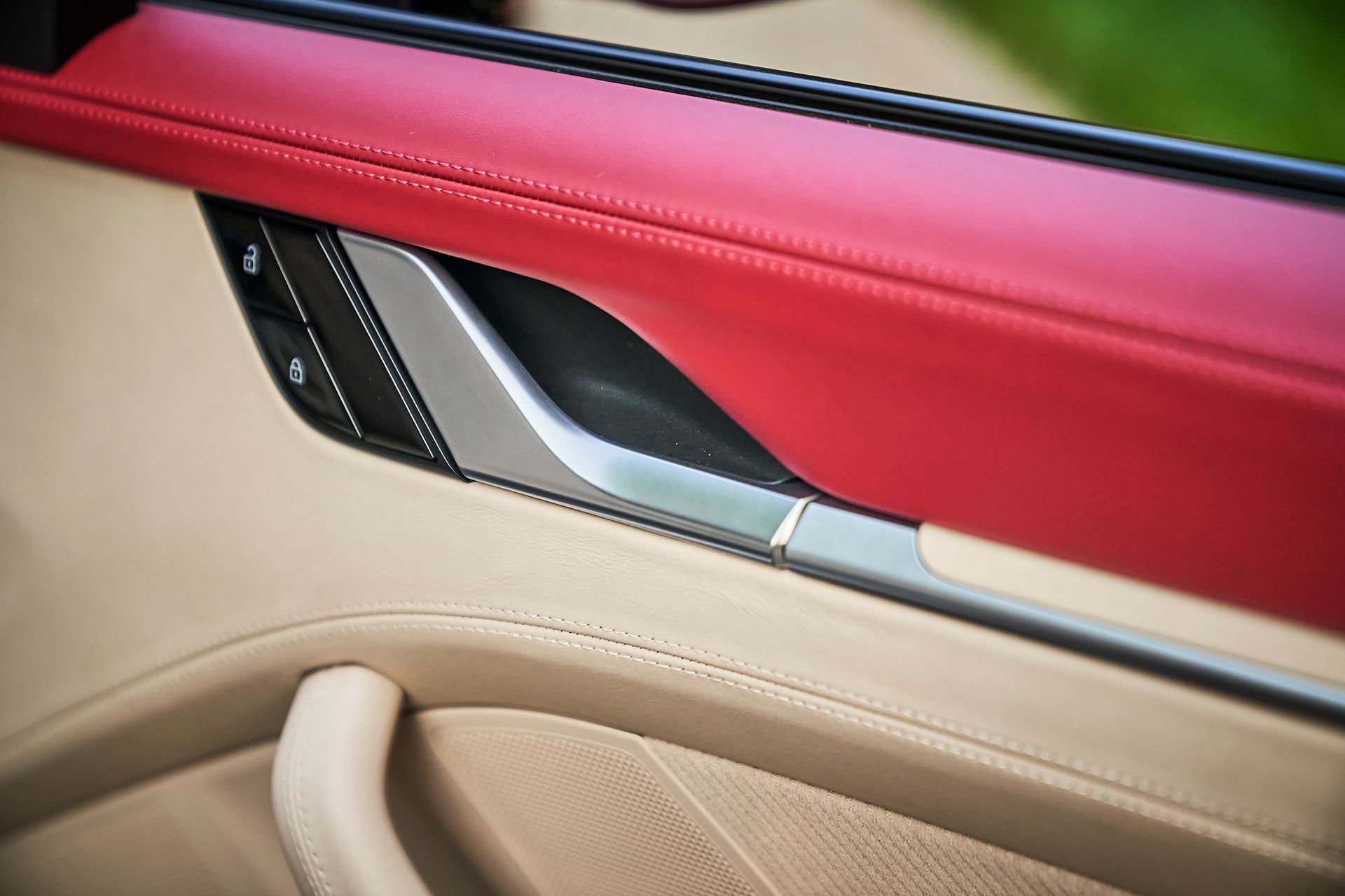 A close up of a car door with a red trim