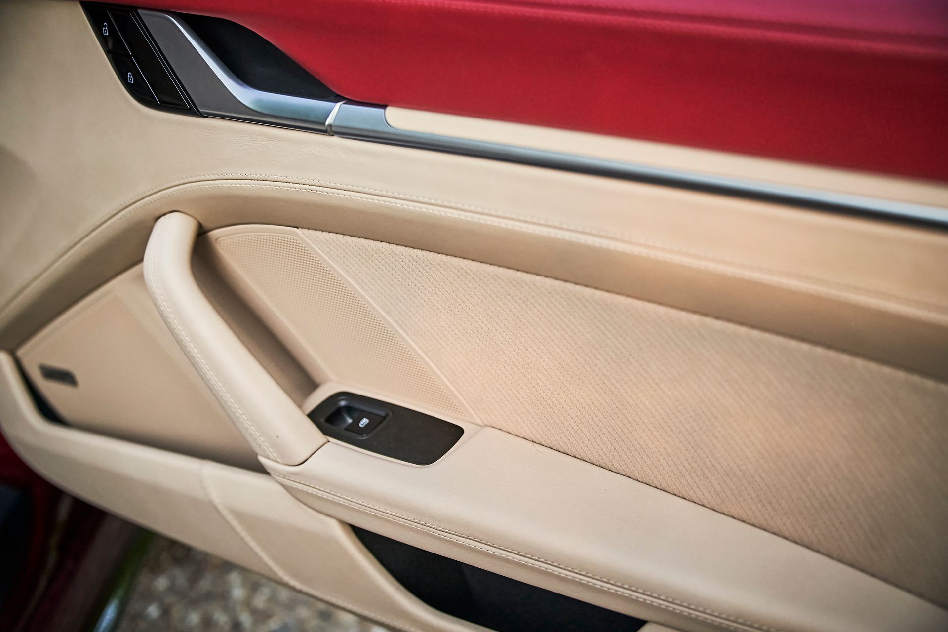 A close up of a car door with a red trim