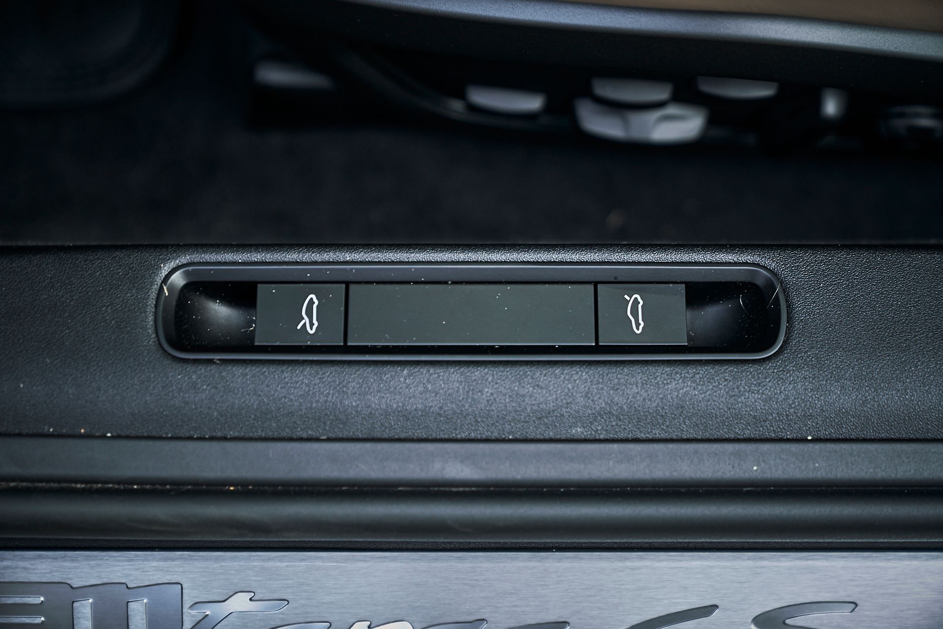 A close up of a car door with two buttons on it