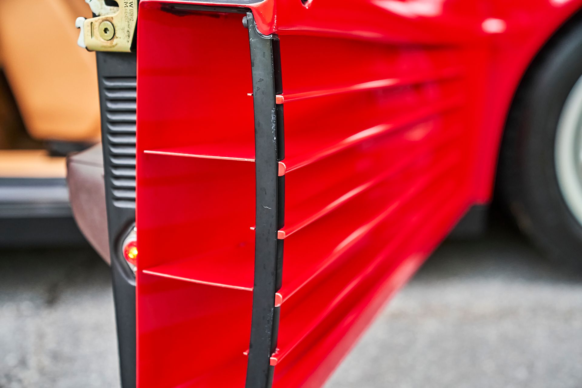 A close up of a red car with the door open.