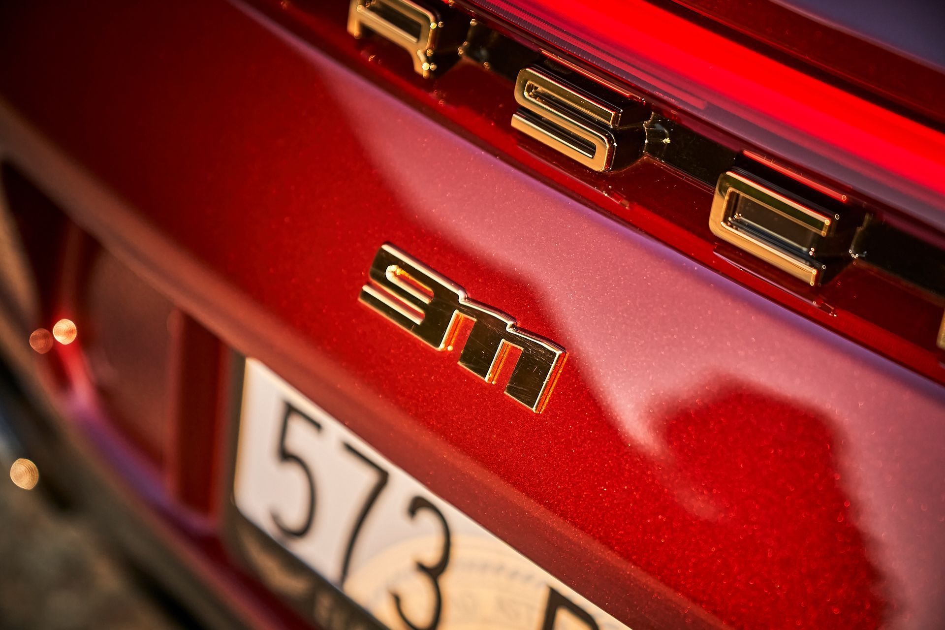 A close up of the back of a red porsche 911