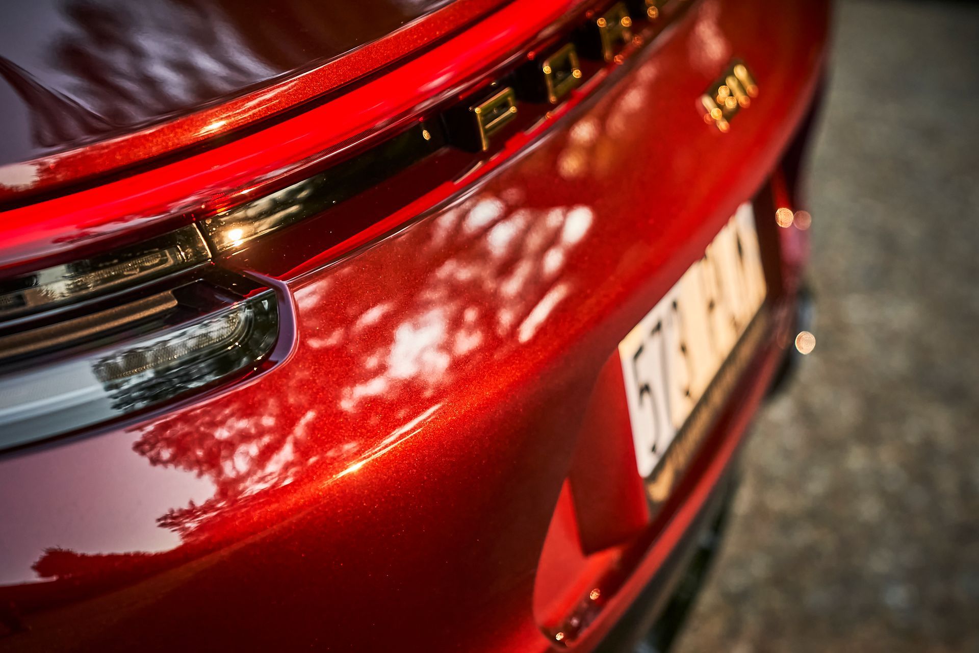 A close up of the back end of a red car.