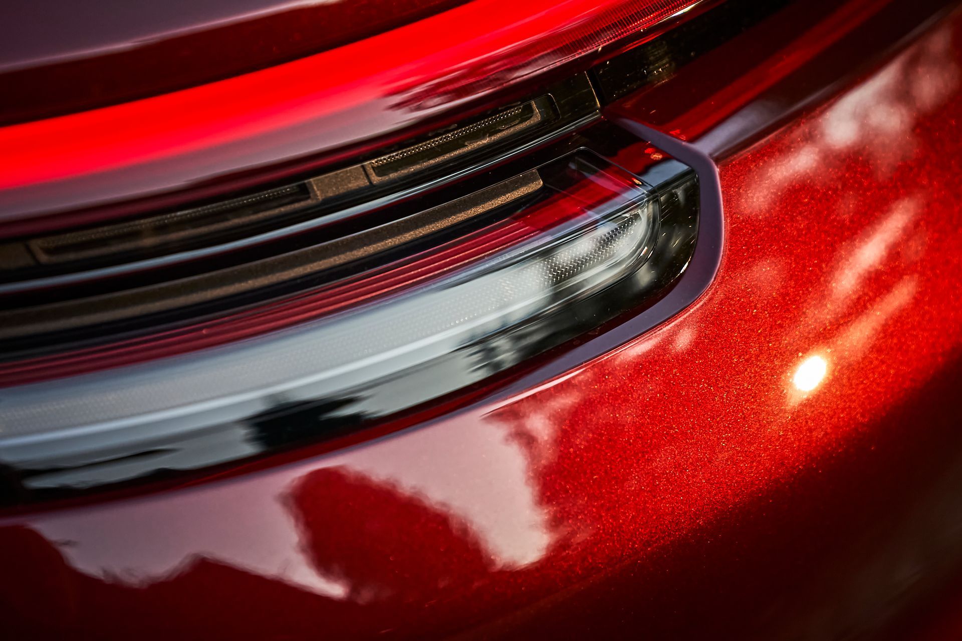 A close up of a red car 's tail light.