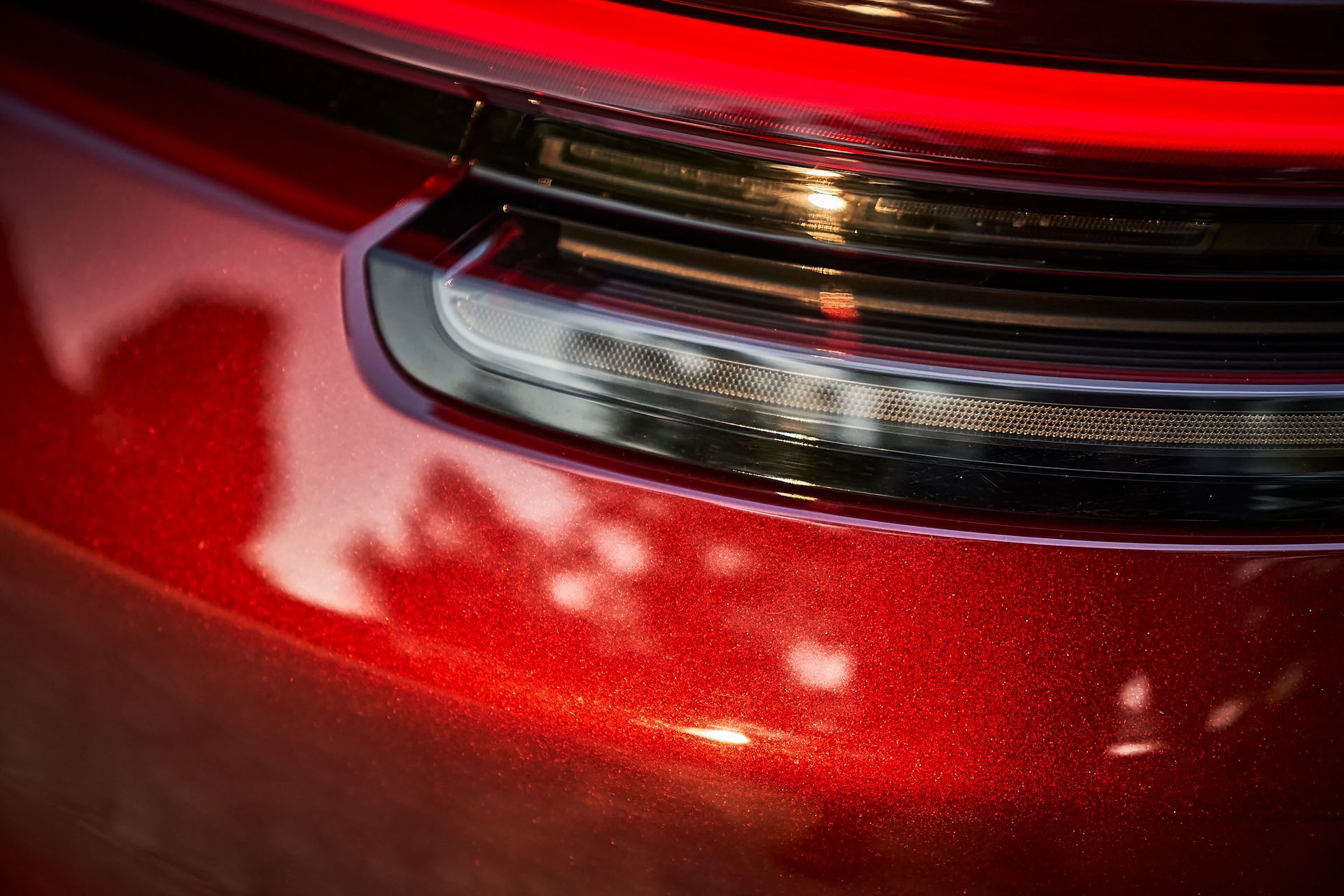 A close up of a red car 's tail light.