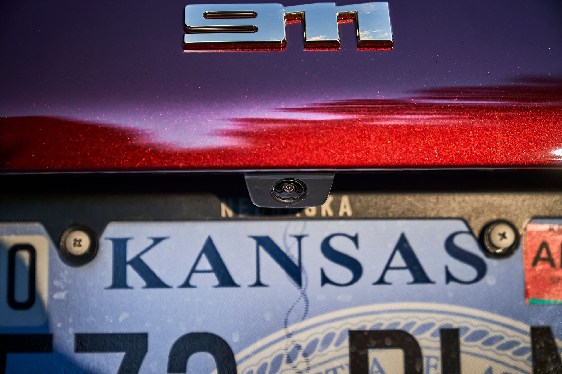 A purple car with a kansas license plate