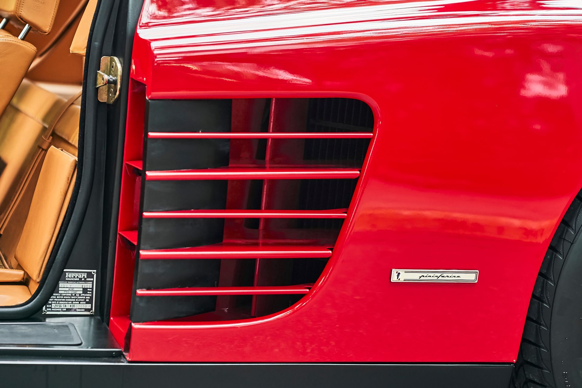 A close up of a red car with the door open