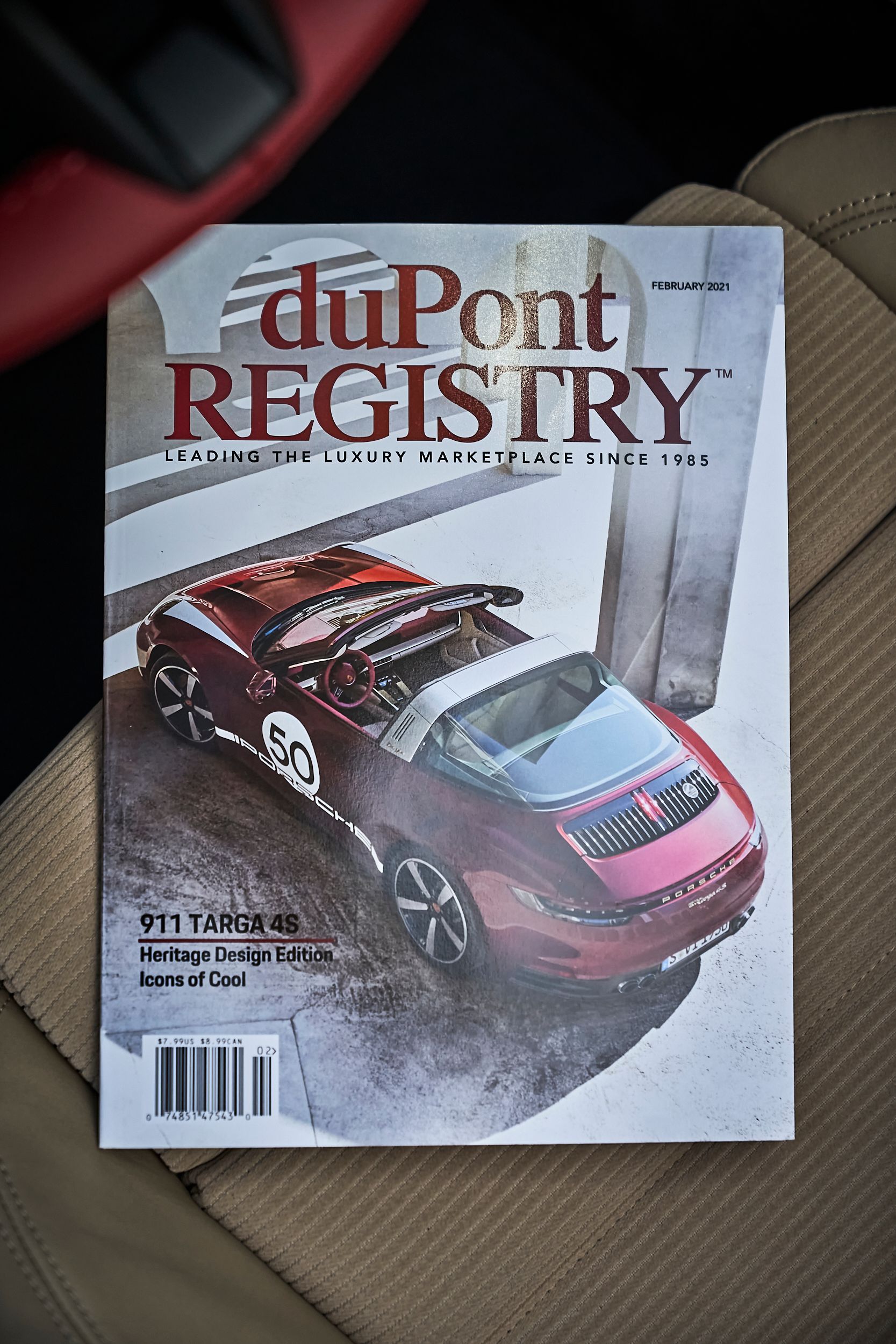 A dupont registry magazine with a red car on the cover