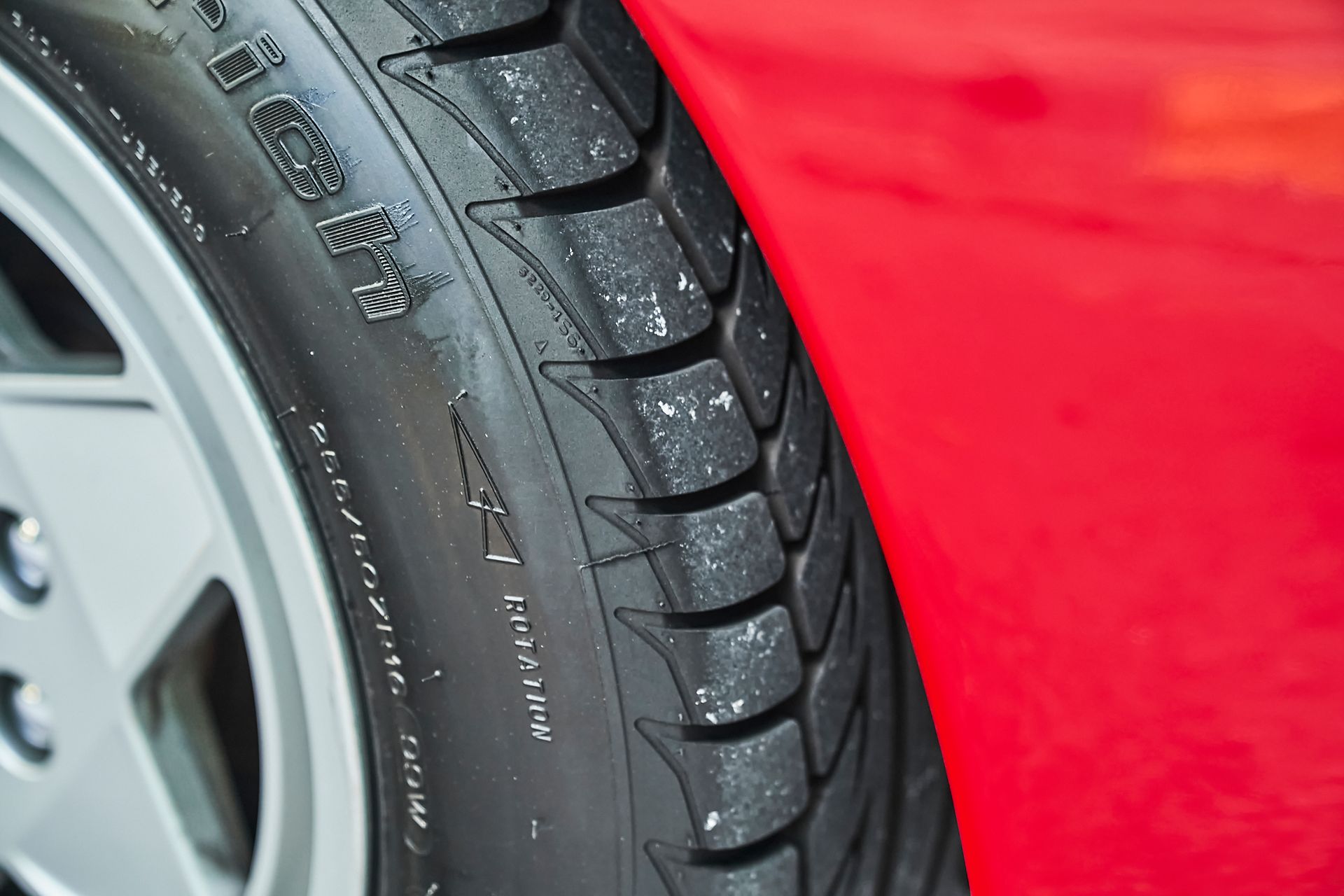 A close up of a tire on a red car
