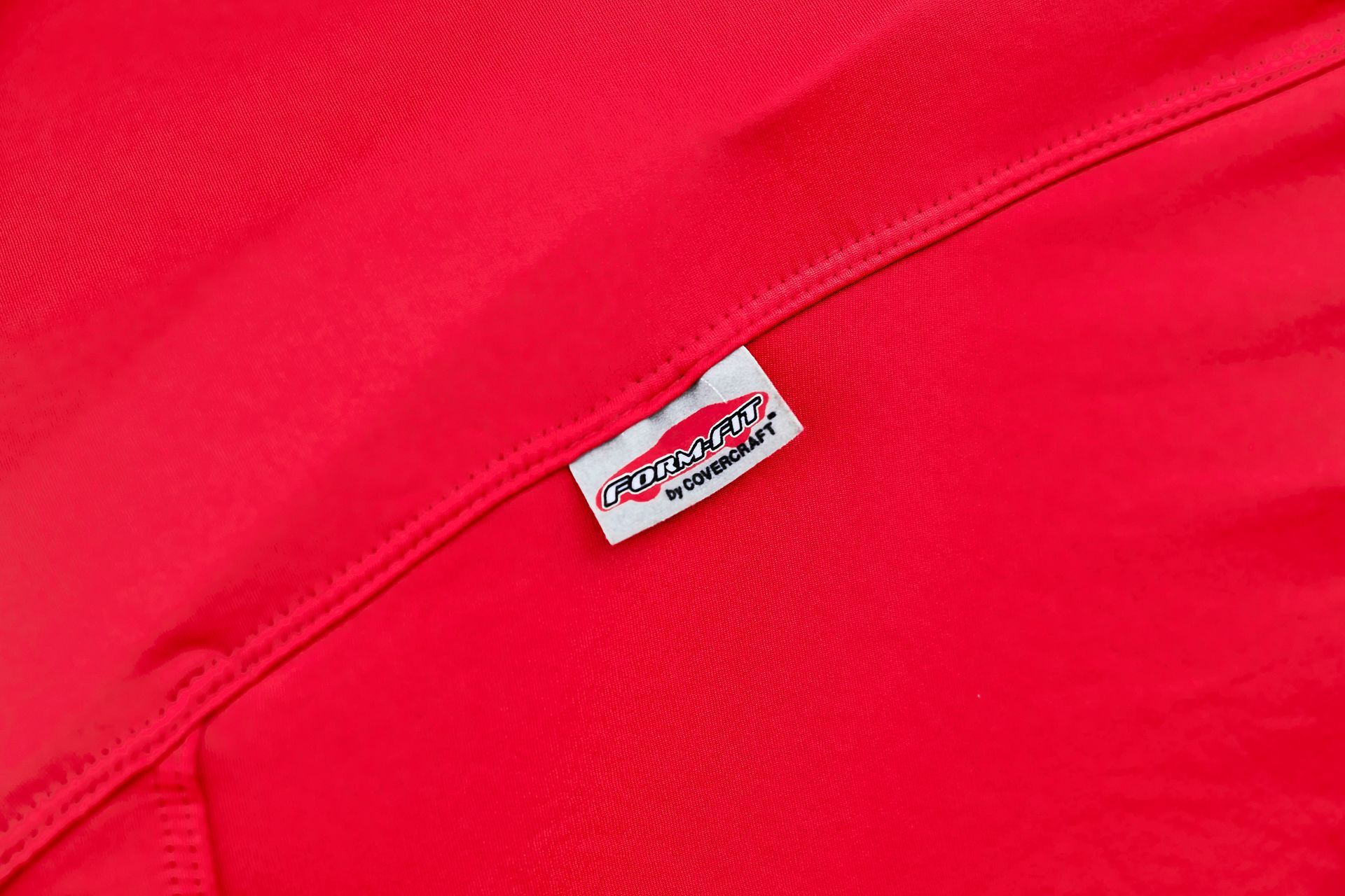 A close up of a red bag with a label on it.
