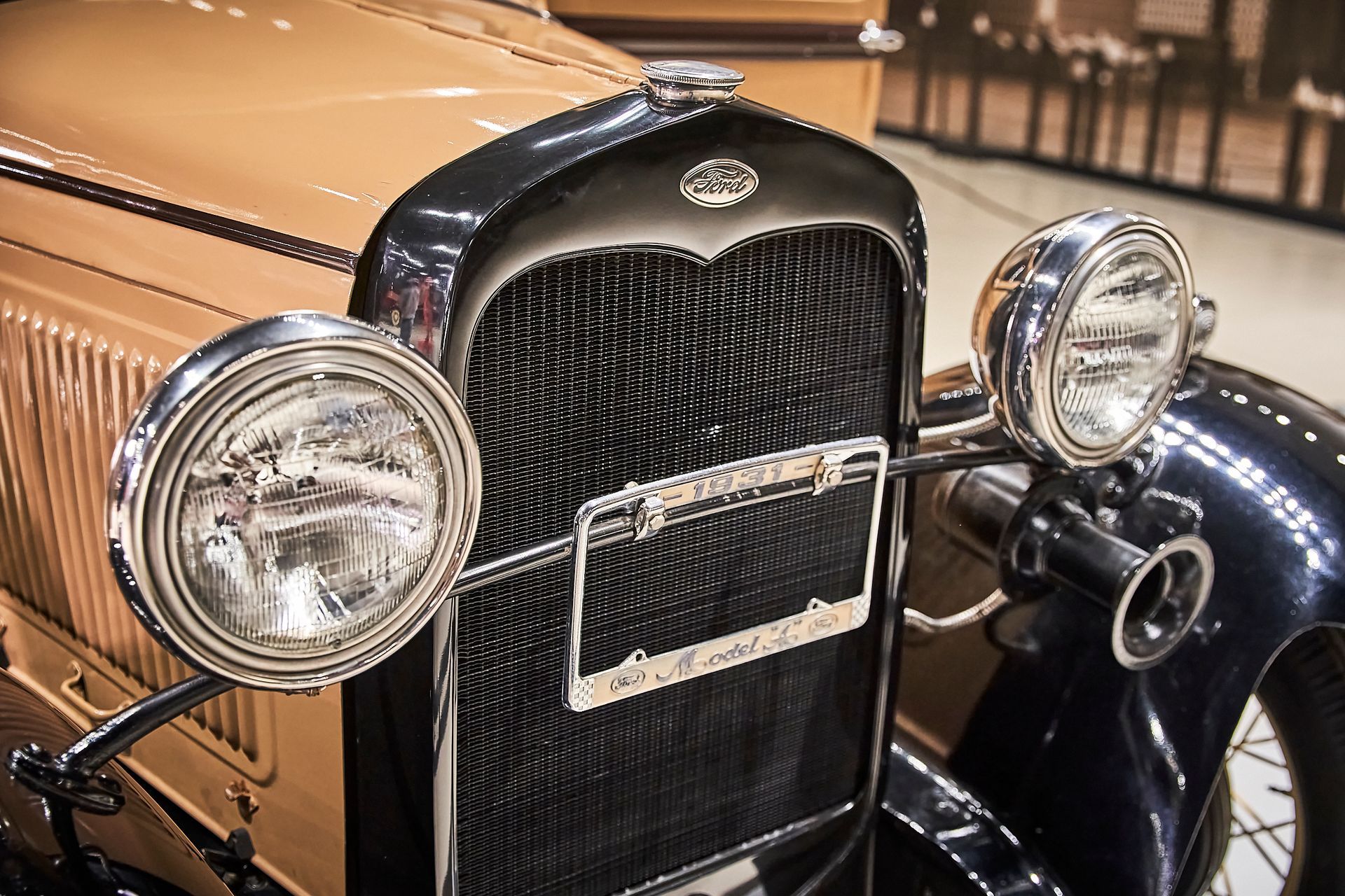 A close up of the front of an old car with two headlights.