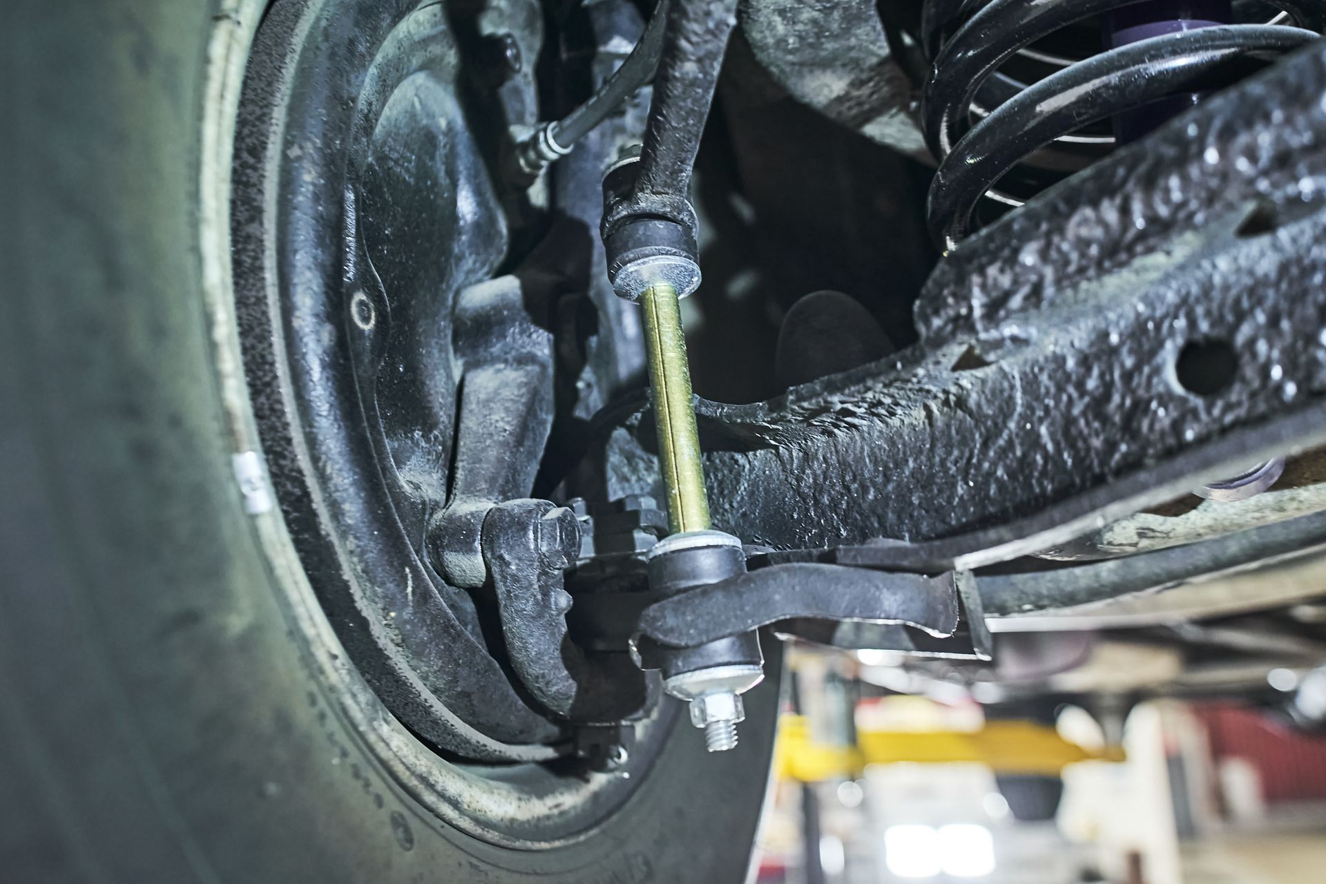A close up of the suspension system of a car.