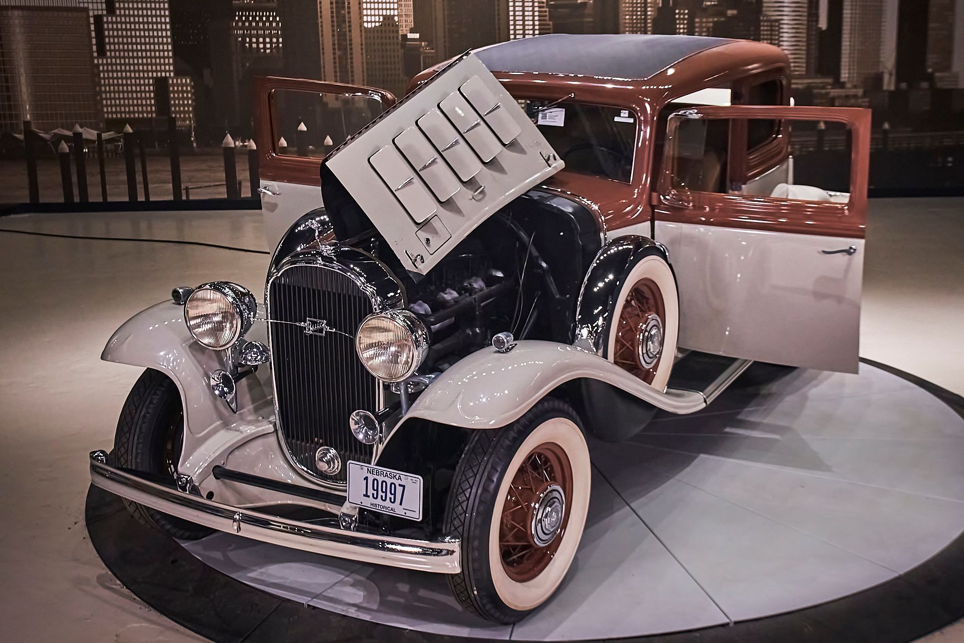 An old car with a sign on the hood that says free