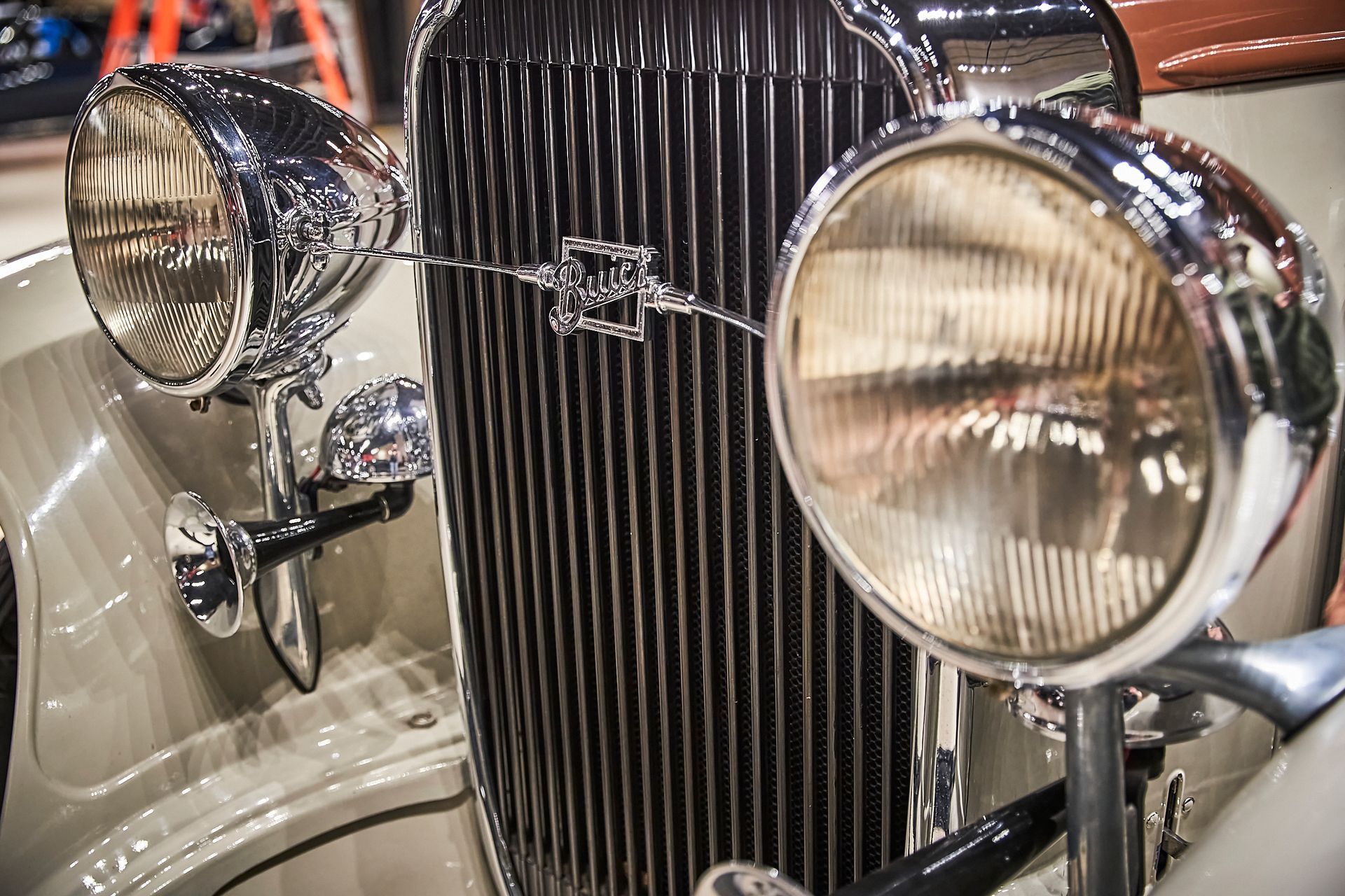 A close up of a car 's headlights and grill.