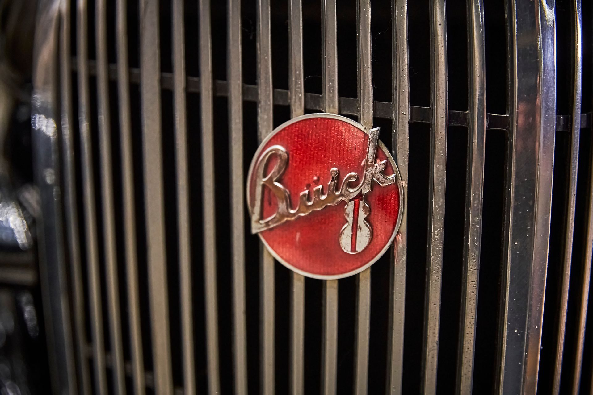 A close up of a buick emblem on the front of a car