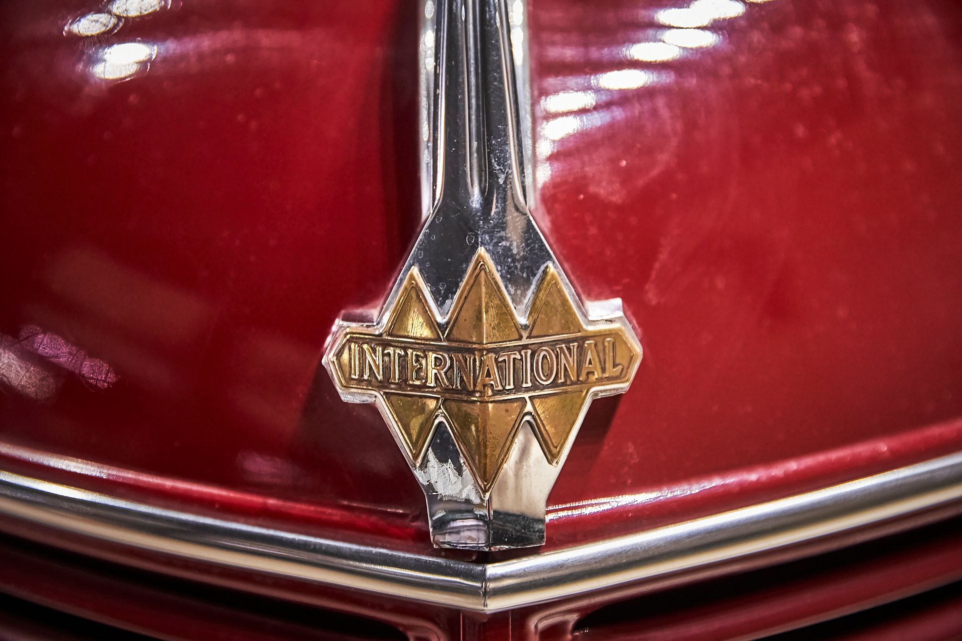 The emblem on the front of a red car says international