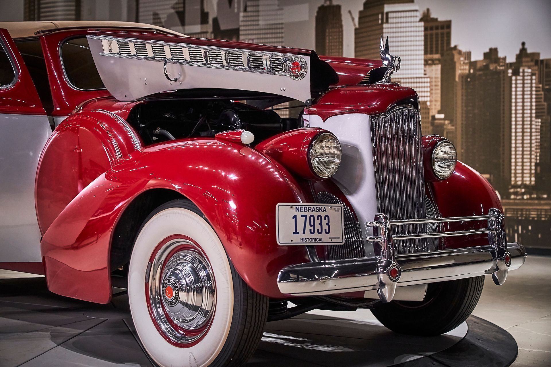 A red car with a license plate that says 17337