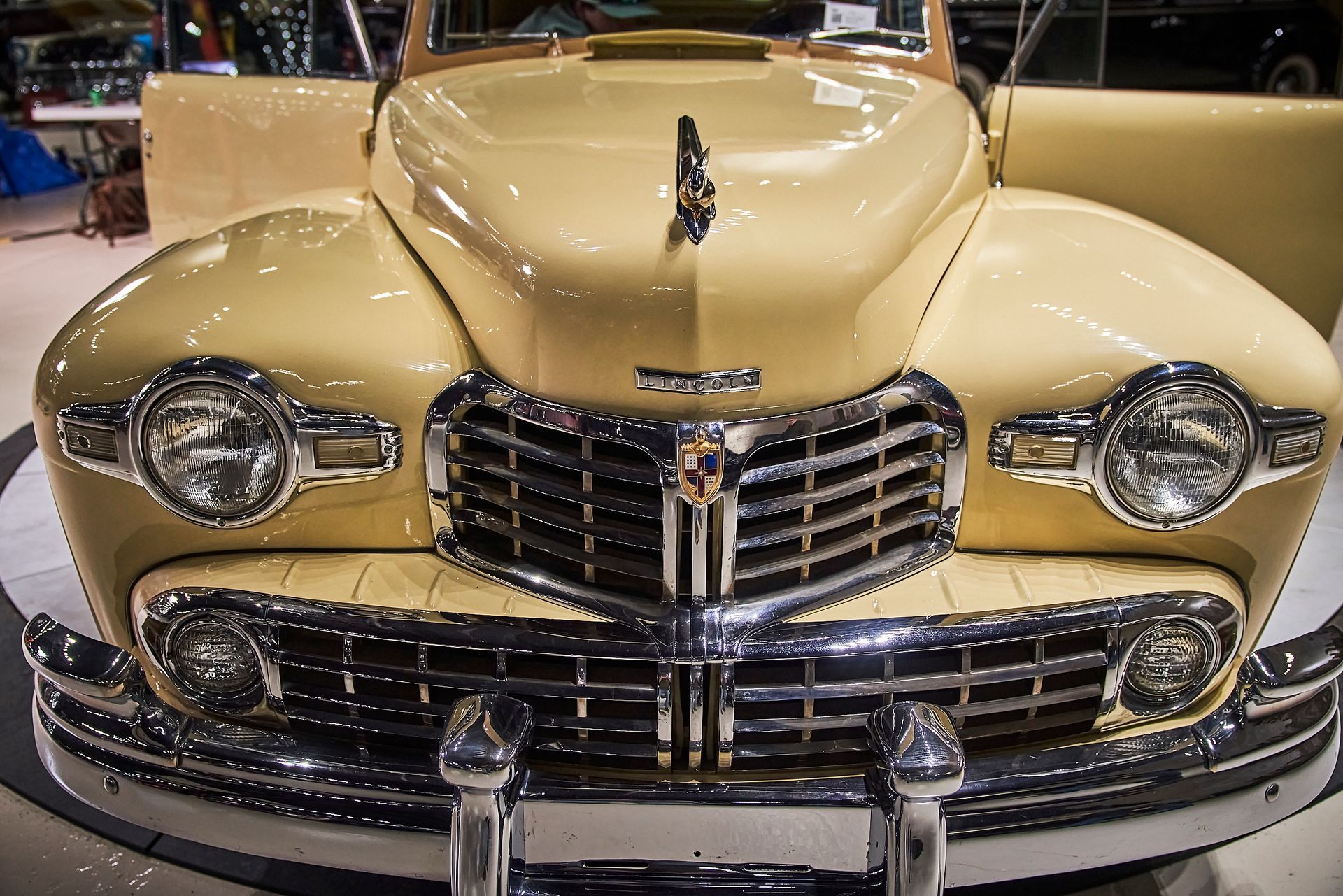 A close up of the front of an old car on display