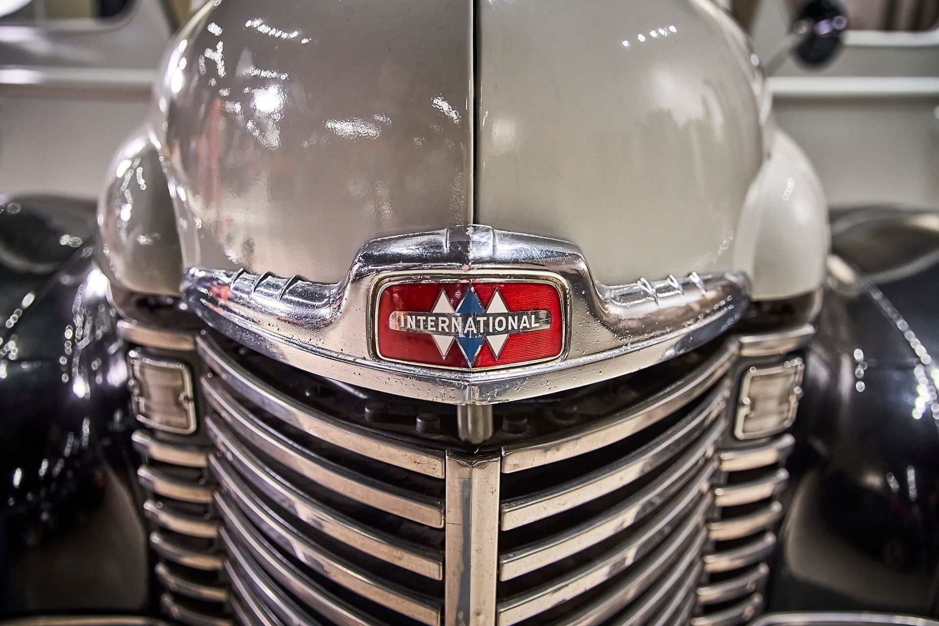 A close up of the front of an old international car