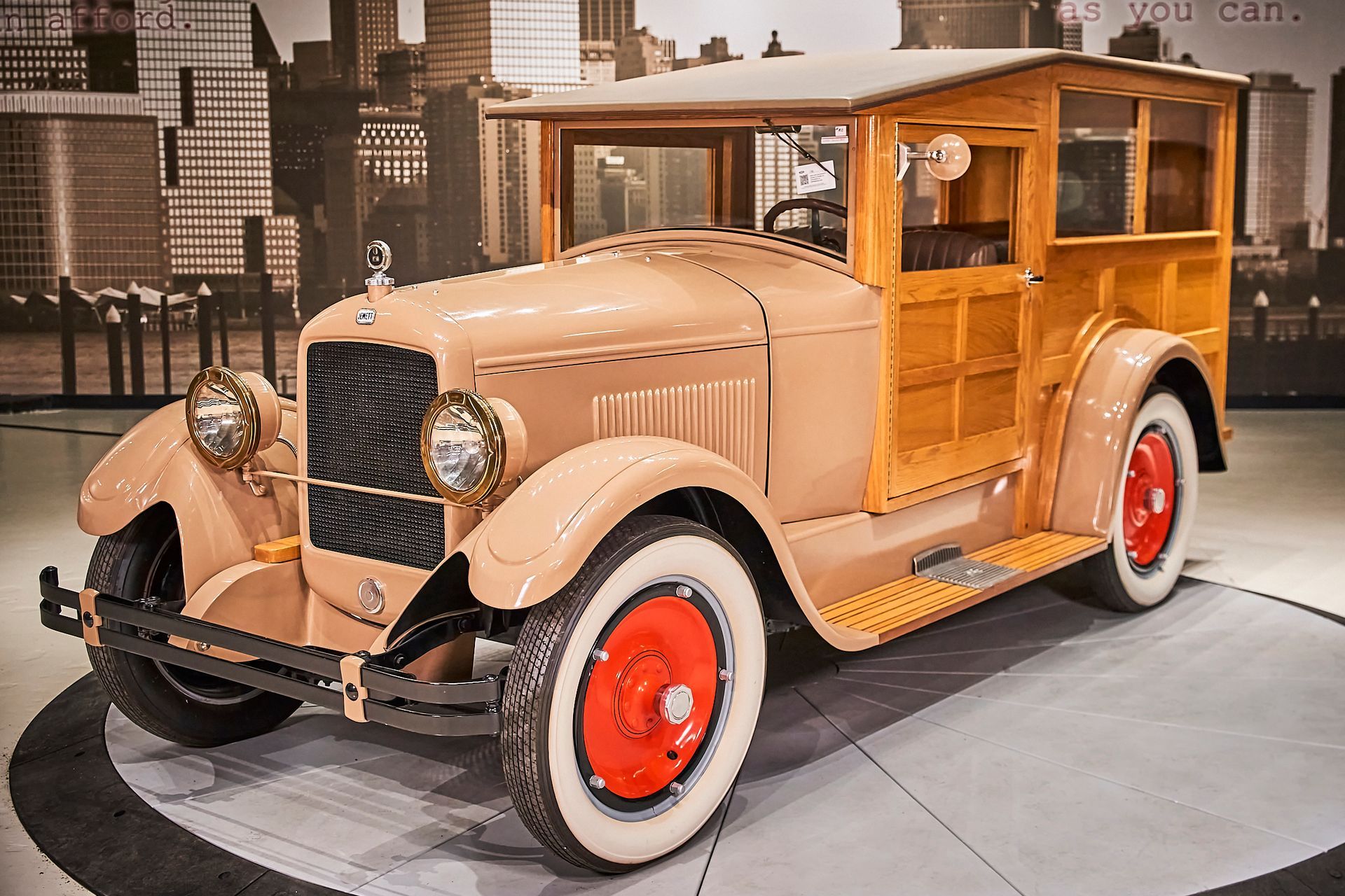 An old wooden wagon with white tires and red rims