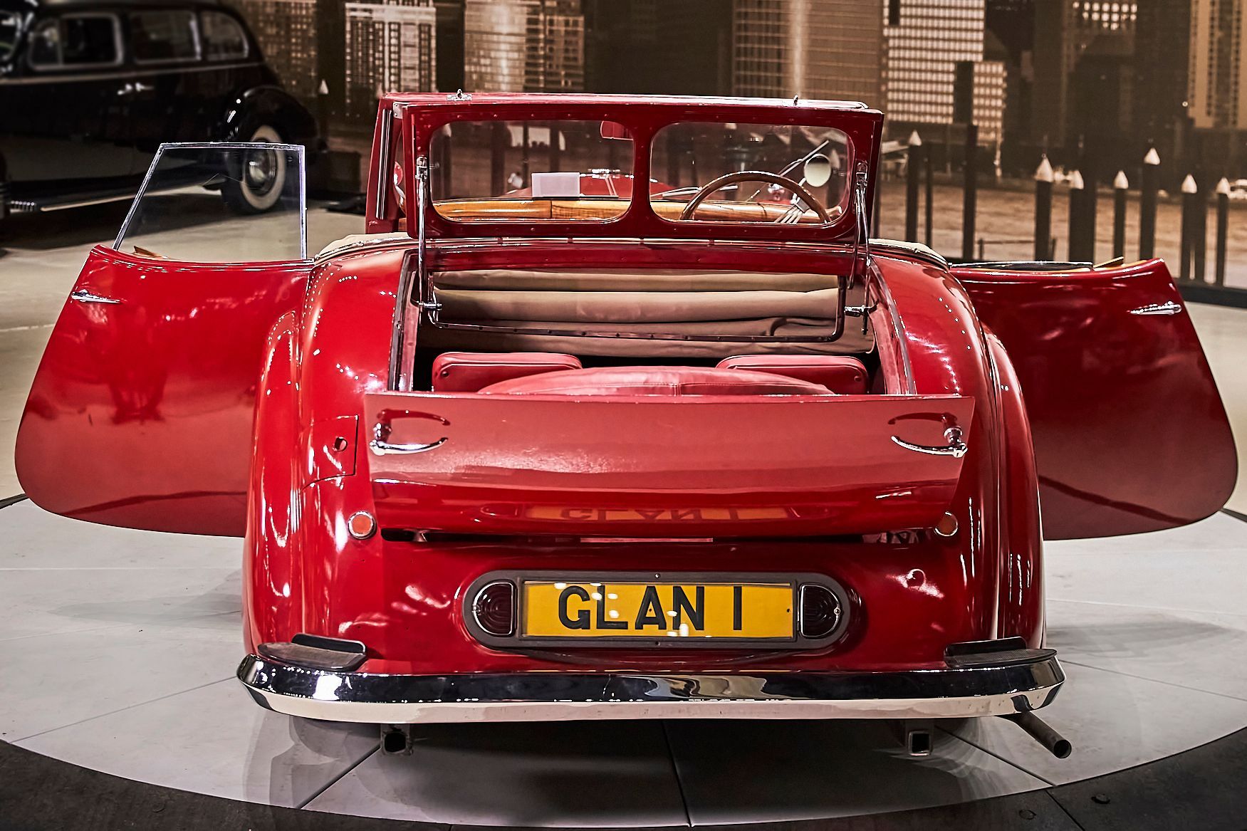 A red car with a license plate that says glan on it