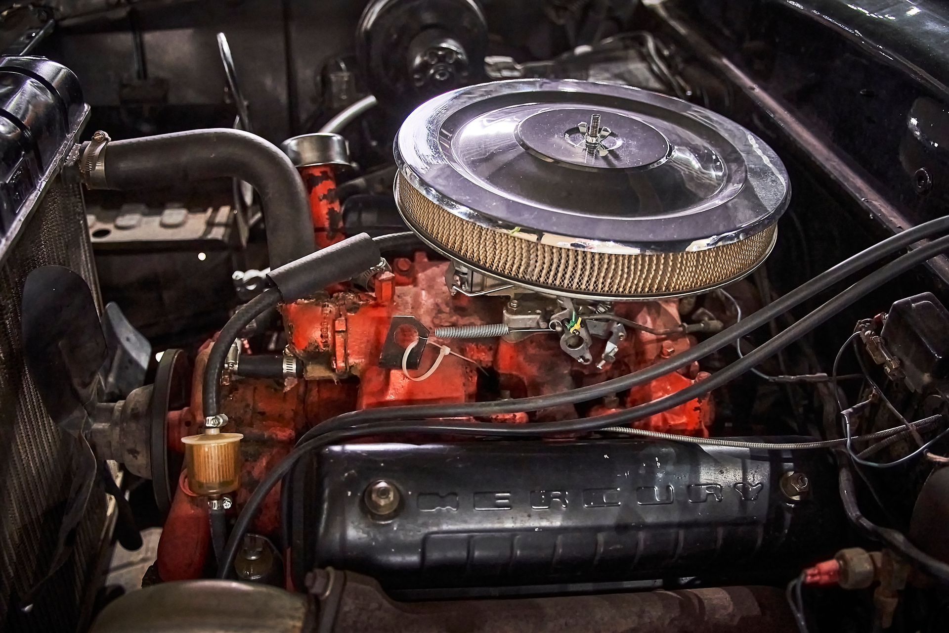 A close up of a car engine with a air filter