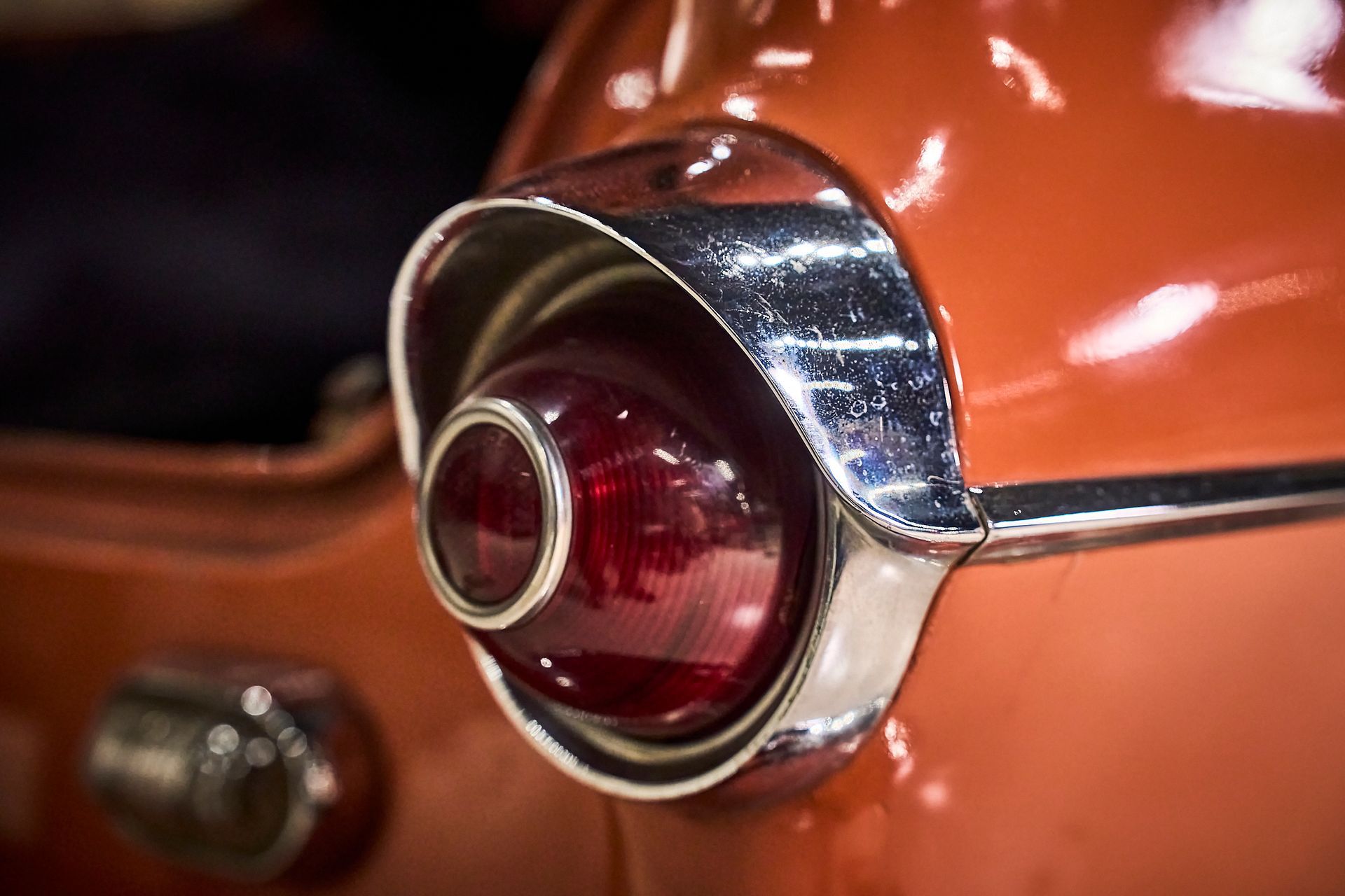 A close up of a red car 's tail light.