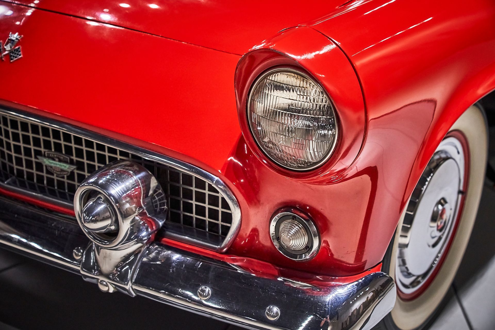 A close up of a red car with white tires