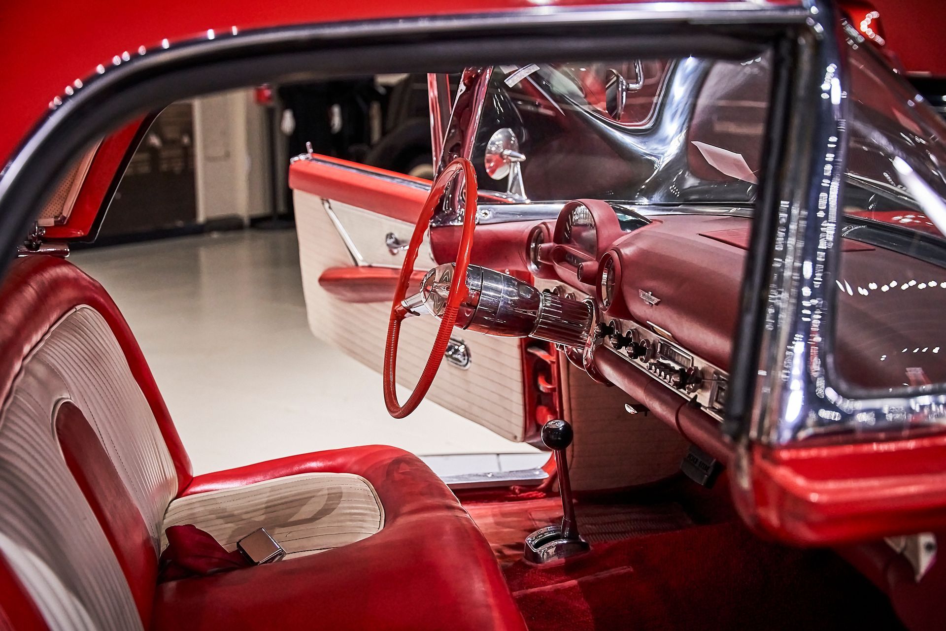 The interior of a red car with a red steering wheel