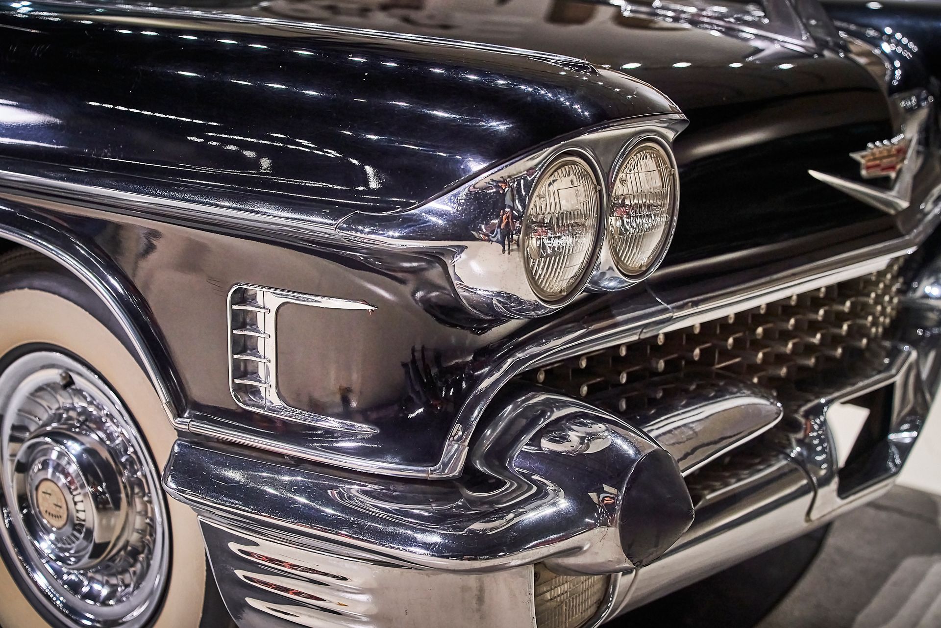 A close up of a black car with white tires