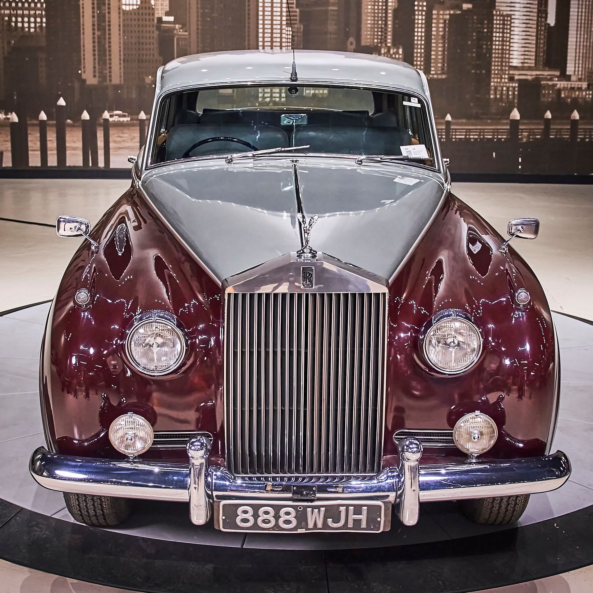 A rolls royce with a license plate that says 888 wjh