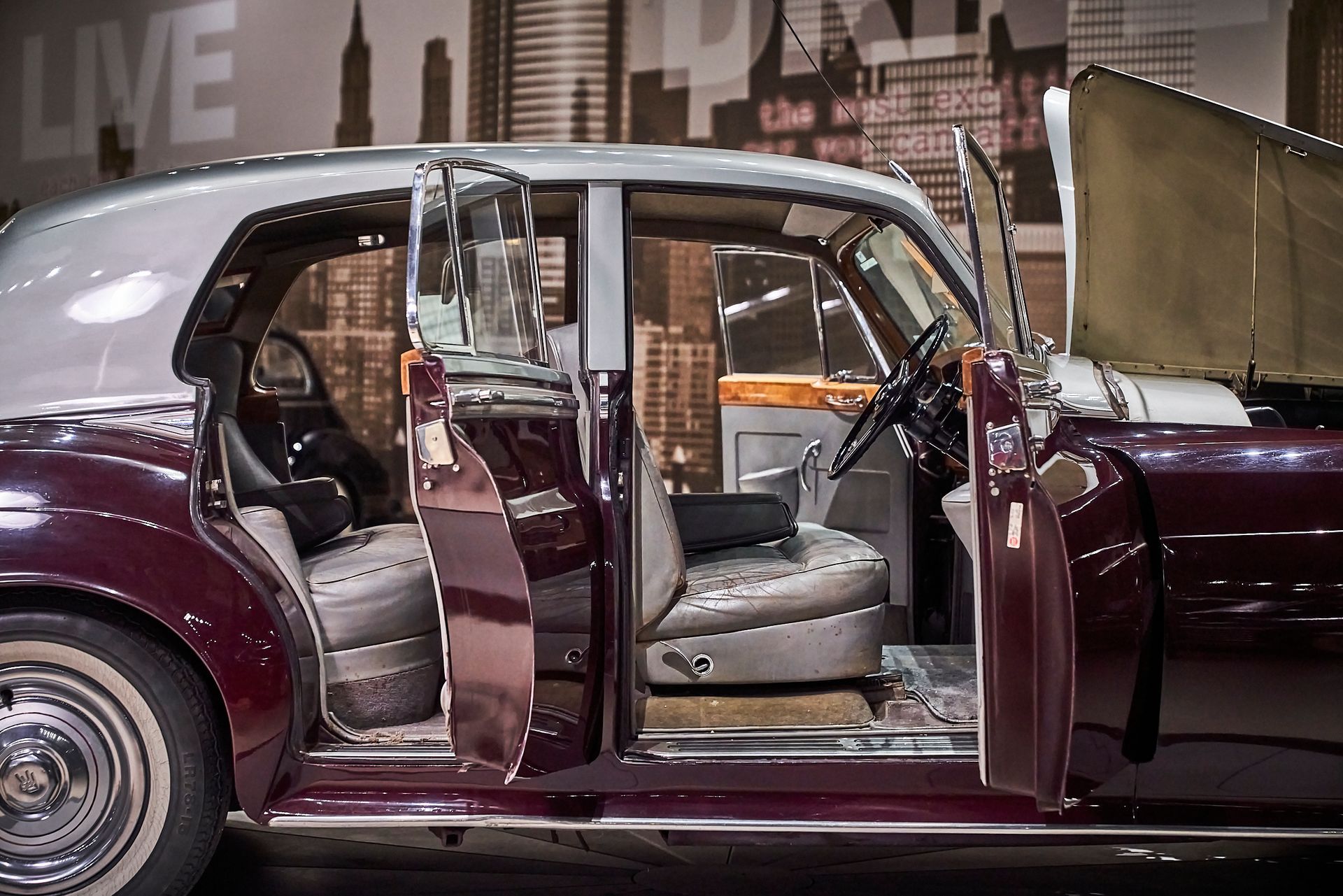 A purple car with the doors open and the hood up