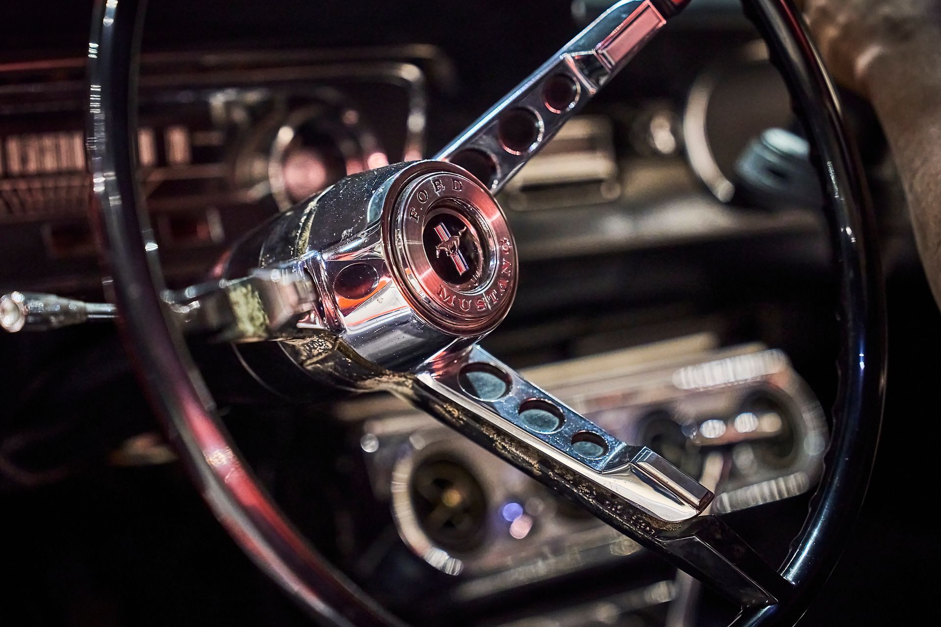 A close up of a steering wheel in a car