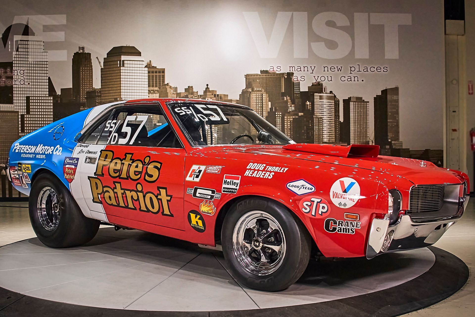 A red and blue race car with pete 's patriot written on the side