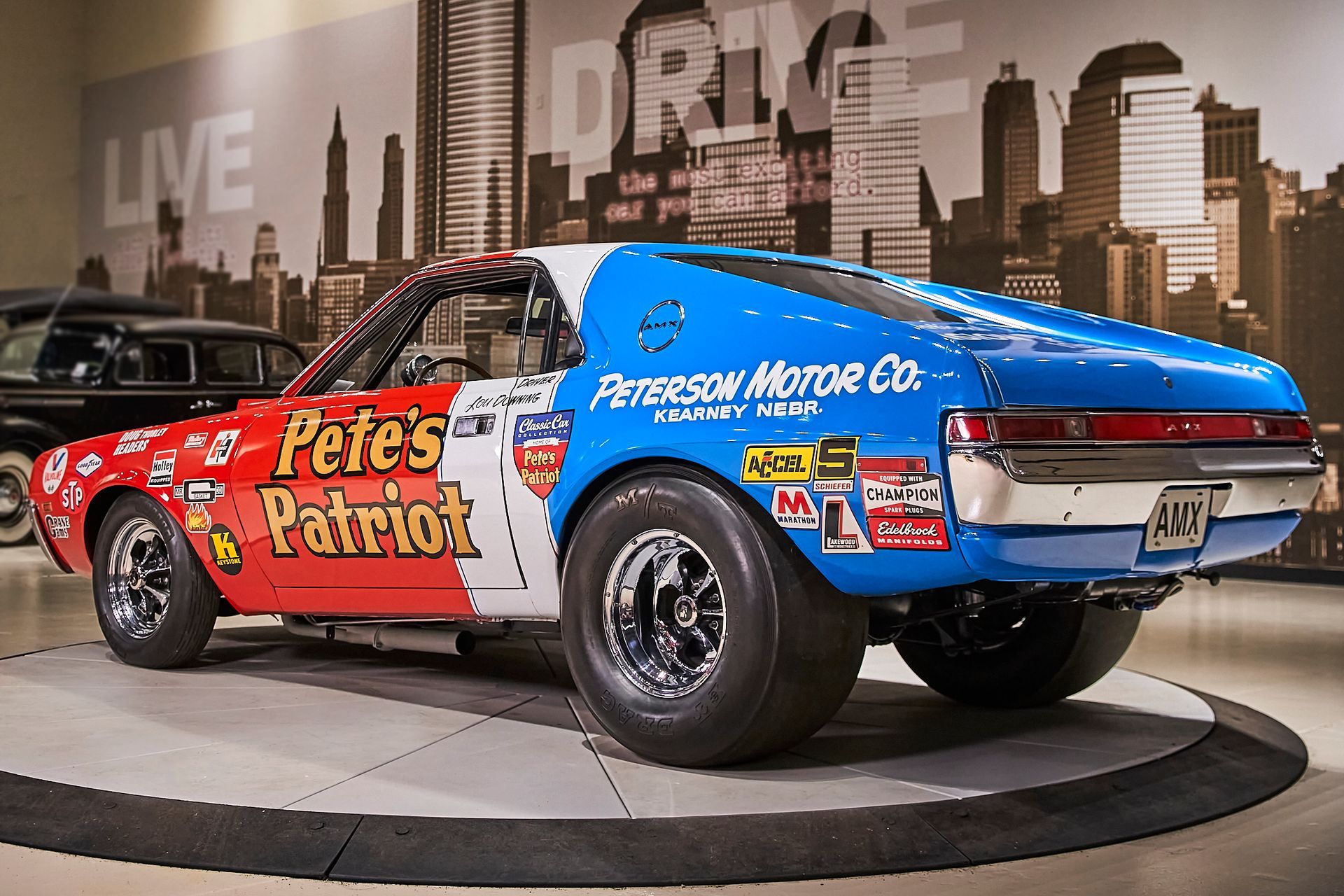 A red white and blue racing car that says pete 's patriot