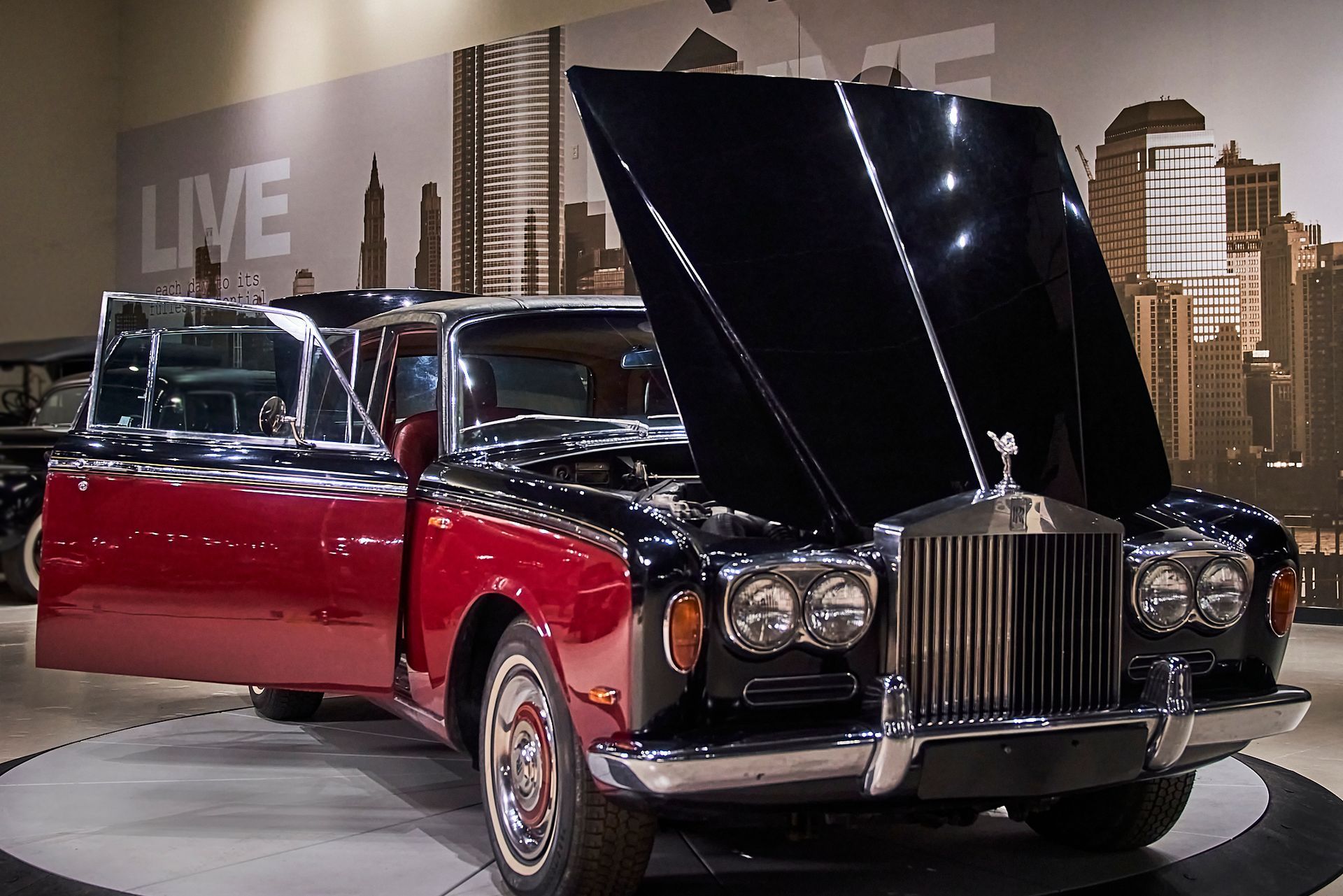 A red and black rolls royce with the hood up