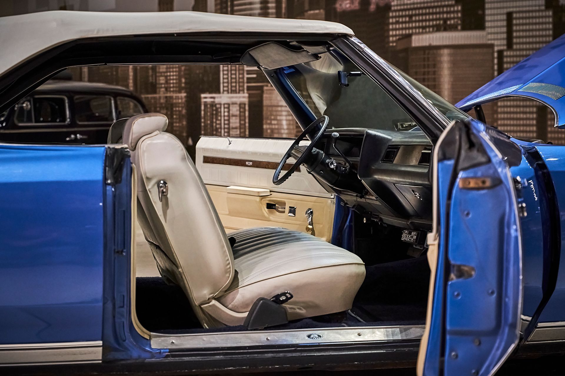 The inside of a blue car with the door open.