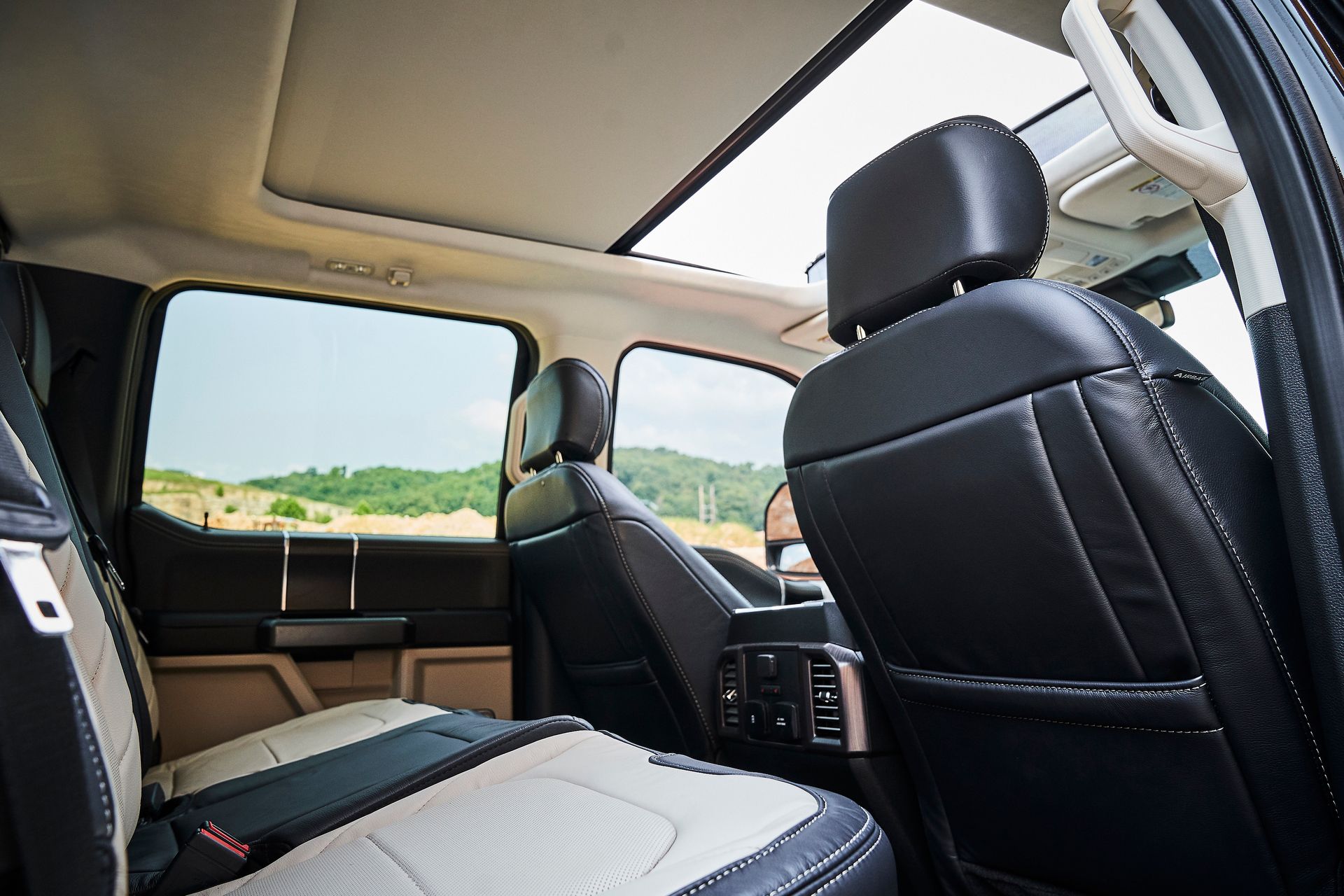 The back seat of a ford truck with a sunroof.