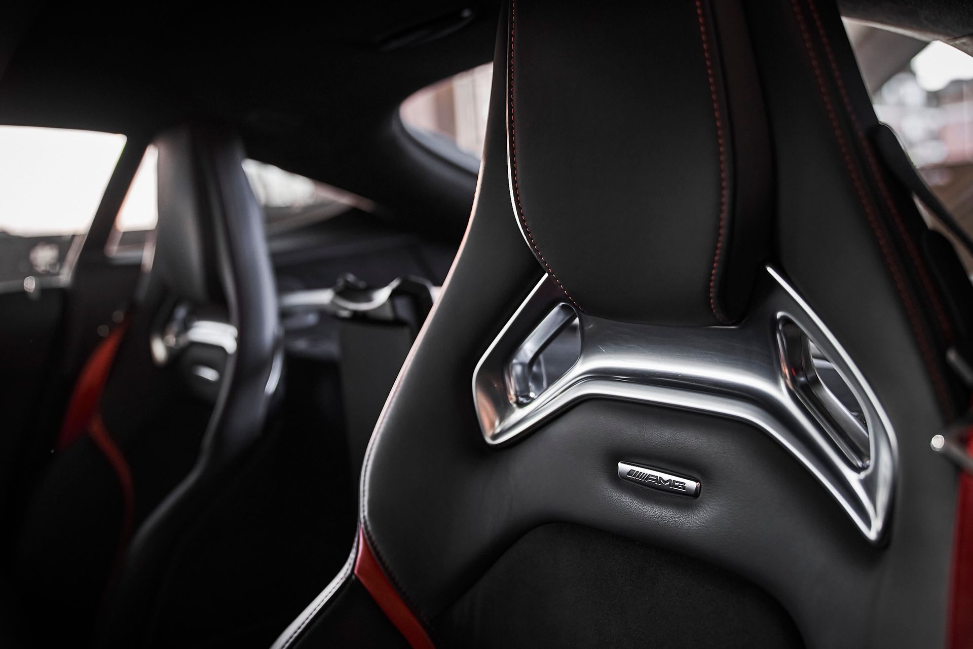 A close up of a car seat with a chrome emblem on it