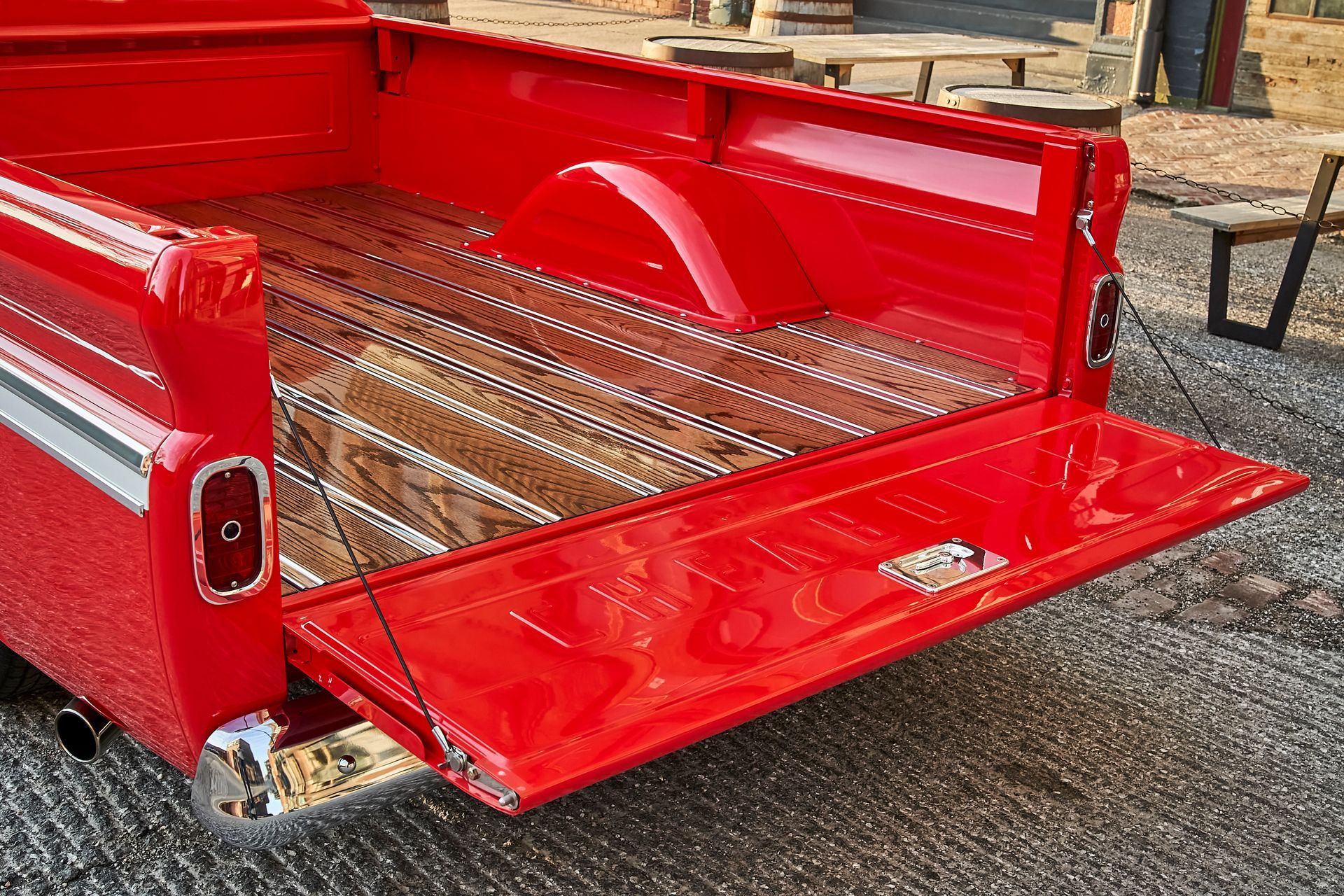 The back of a red truck with the tailgate open.
