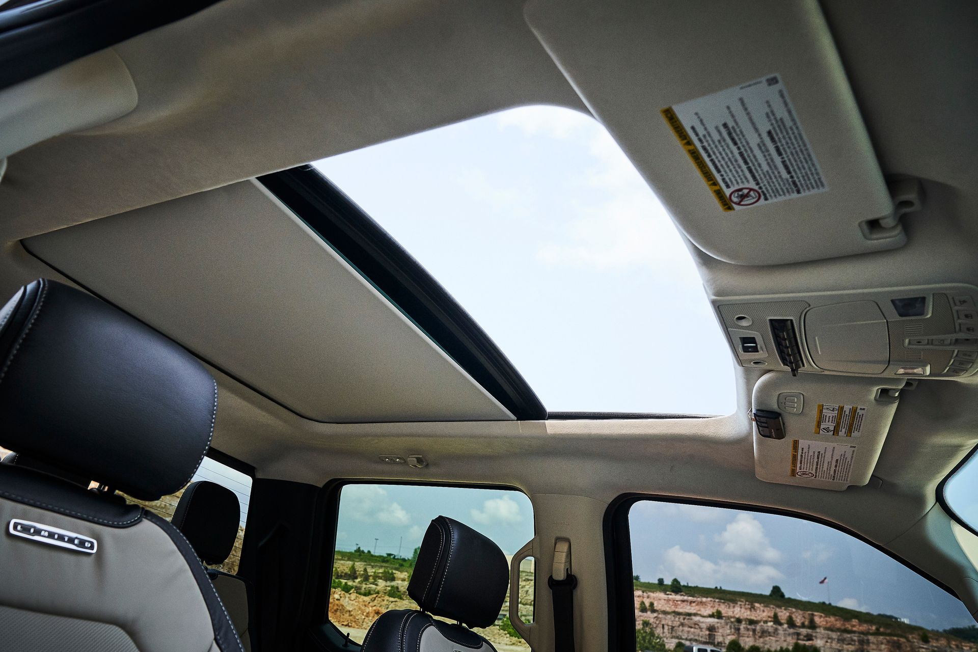 The sunroof of a car with a warning label on it