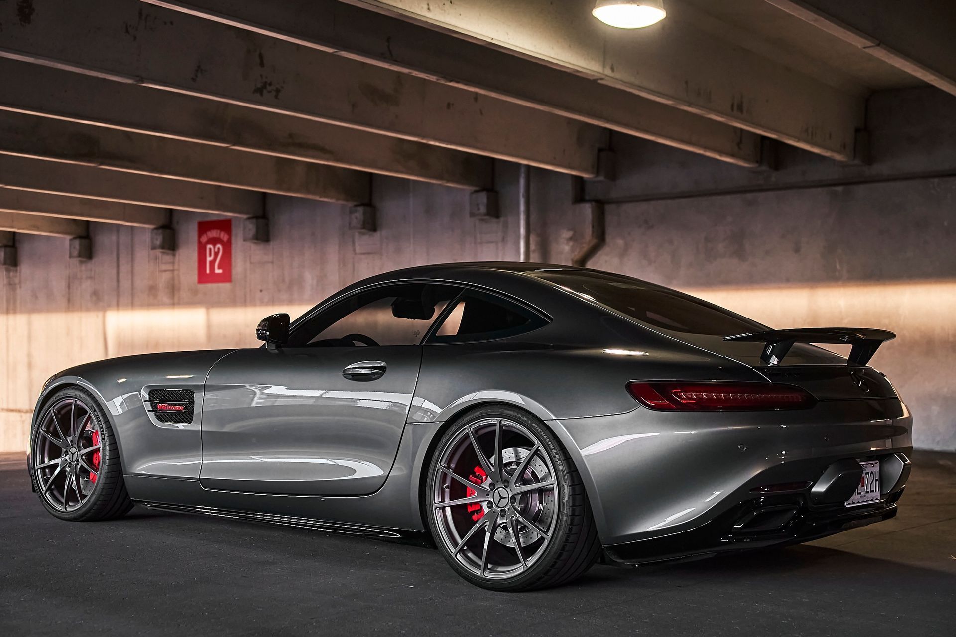 A mercedes amg gt is parked in a parking garage.
